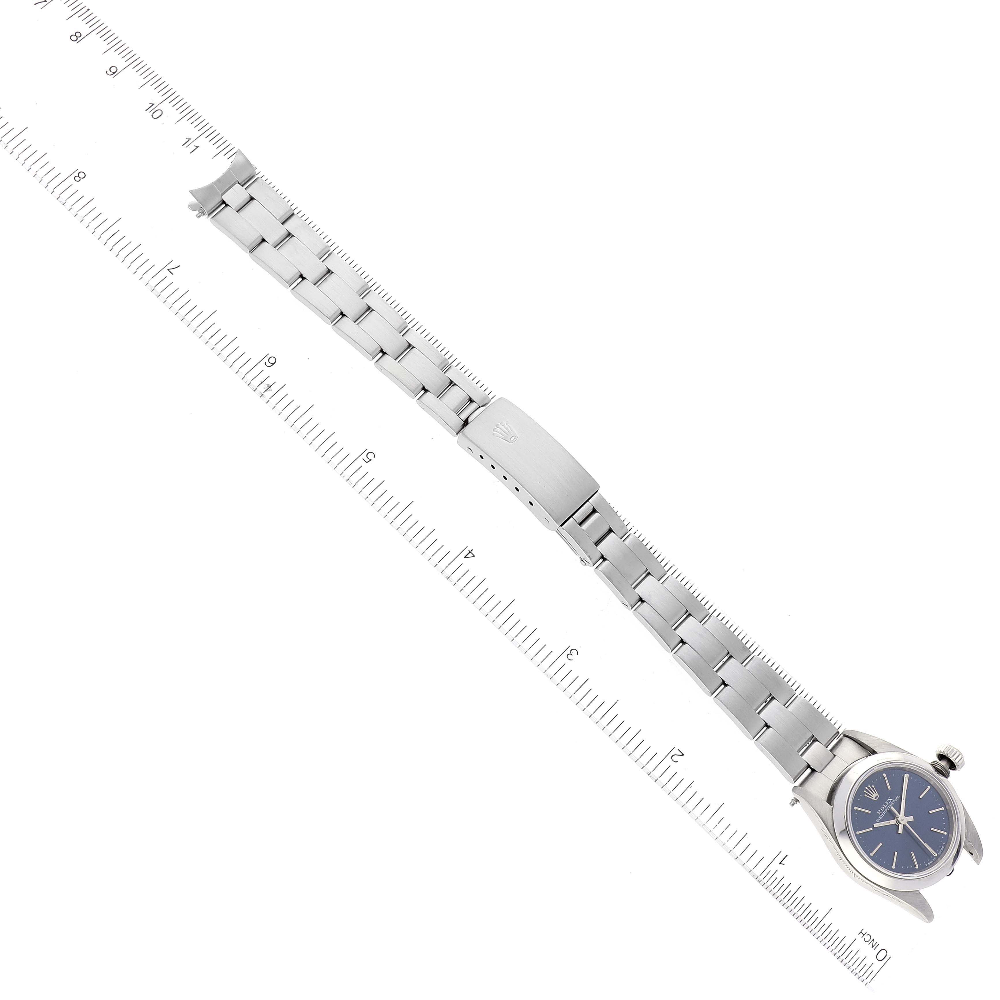 The image shows a top-down view of a Rolex Oyster Perpetual 67180 Women's Stainless Steel Blue Dial 67180 Women's Stainless Steel Blue Dial watch, highlighting the bracelet and clasp.