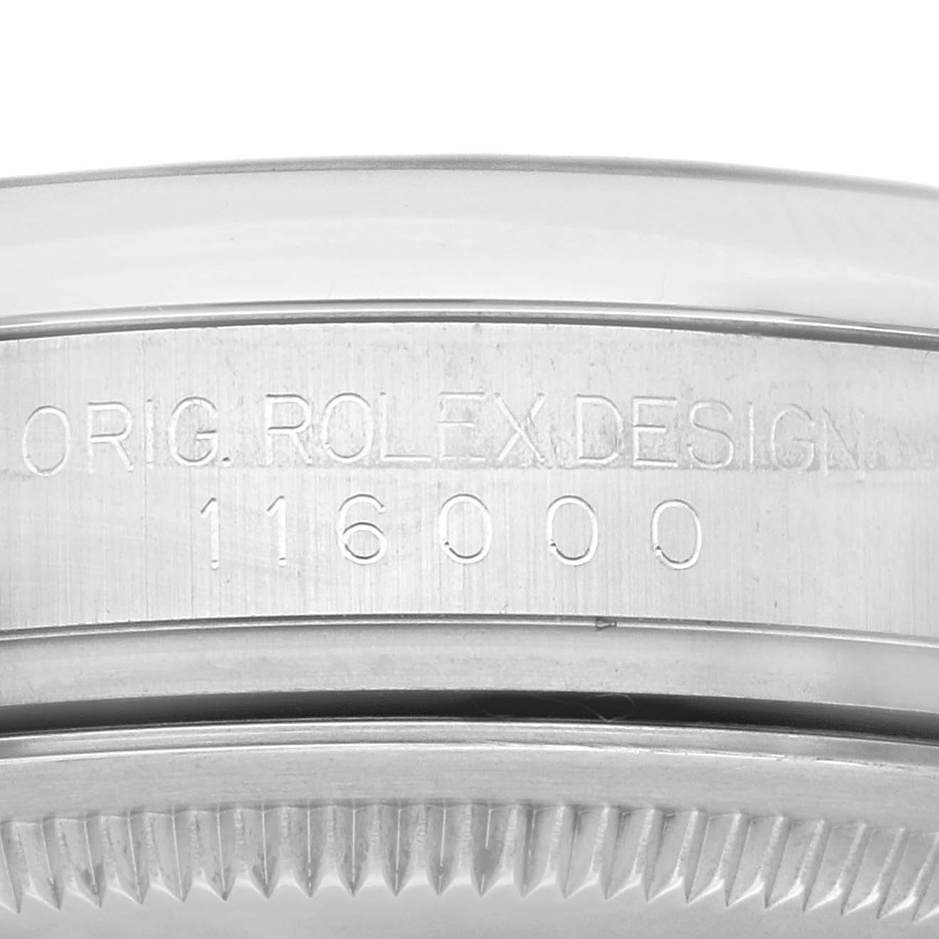 This image shows a close-up of the edge of the case of a Rolex Oyster Perpetual 116000 Men
s Stainless Steel Purple Dial 116000 Men
s Stainless Steel Purple Dial model, highlighting the engraving with the model number 116000.