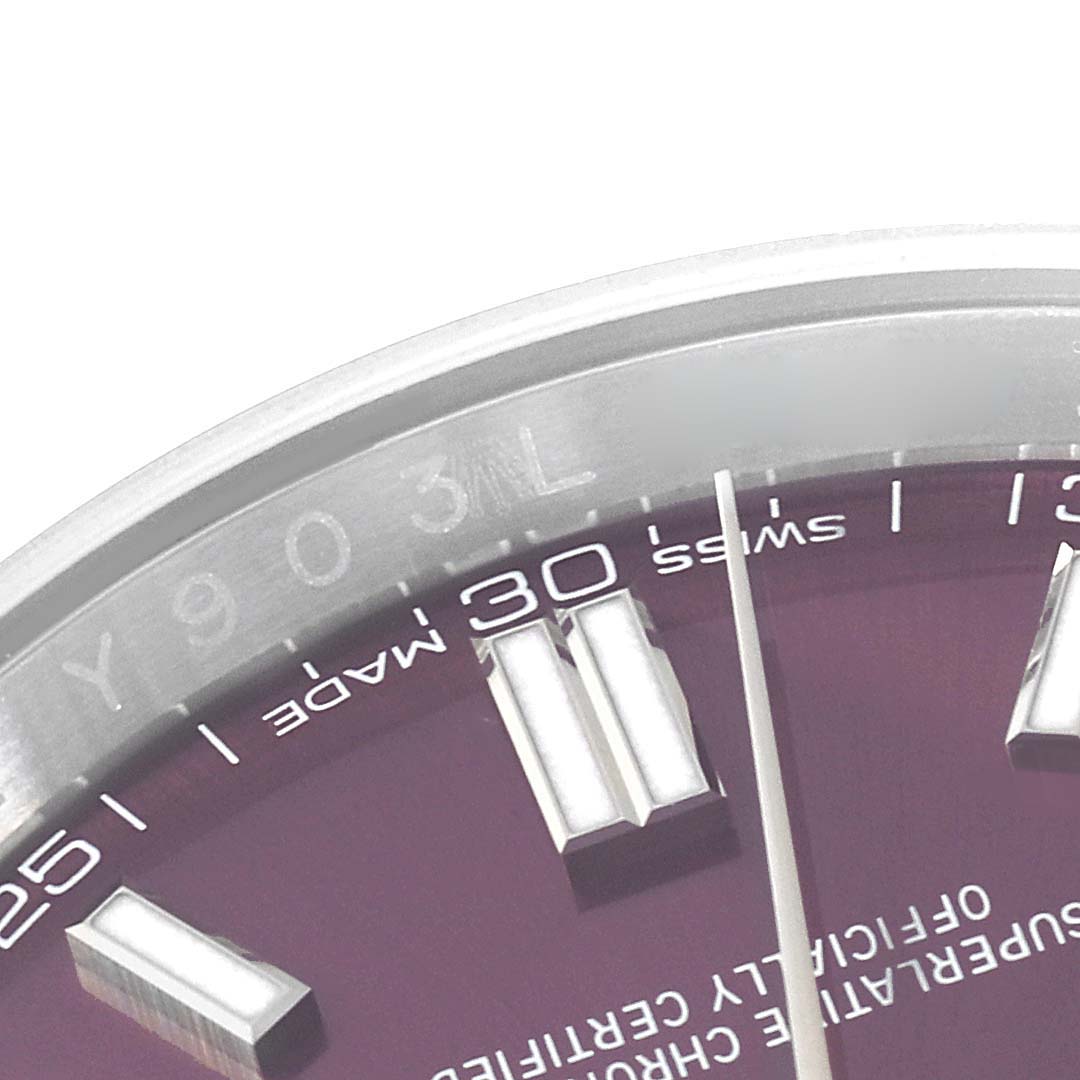 The image shows a close-up of the dial, bezel, and hour markers of a Rolex Oyster Perpetual 116000 Men
s Stainless Steel Purple Dial 116000 Men
s Stainless Steel Purple Dial watch.