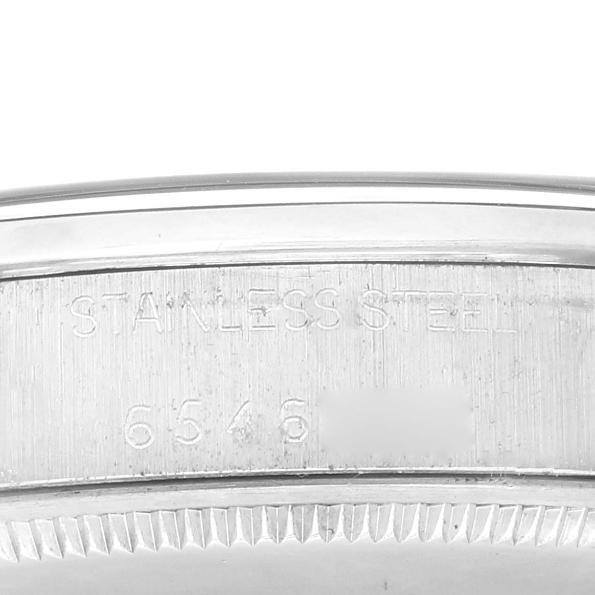 The image shows a close-up of the side of the case of a Rolex Vintage Collection 1002 Men's Stainless Steel Silver Dial 1002 Men's Stainless Steel Silver Dial watch, highlighting the stainless steel material and model number.