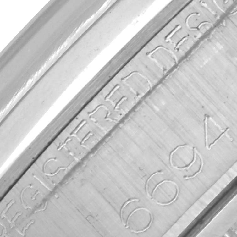 The image shows a close-up of the inner engraving on the case back of a Rolex Date 6694 Men's Stainless Steel Silver Dial 6694 Men's Stainless Steel Silver Dial watch.