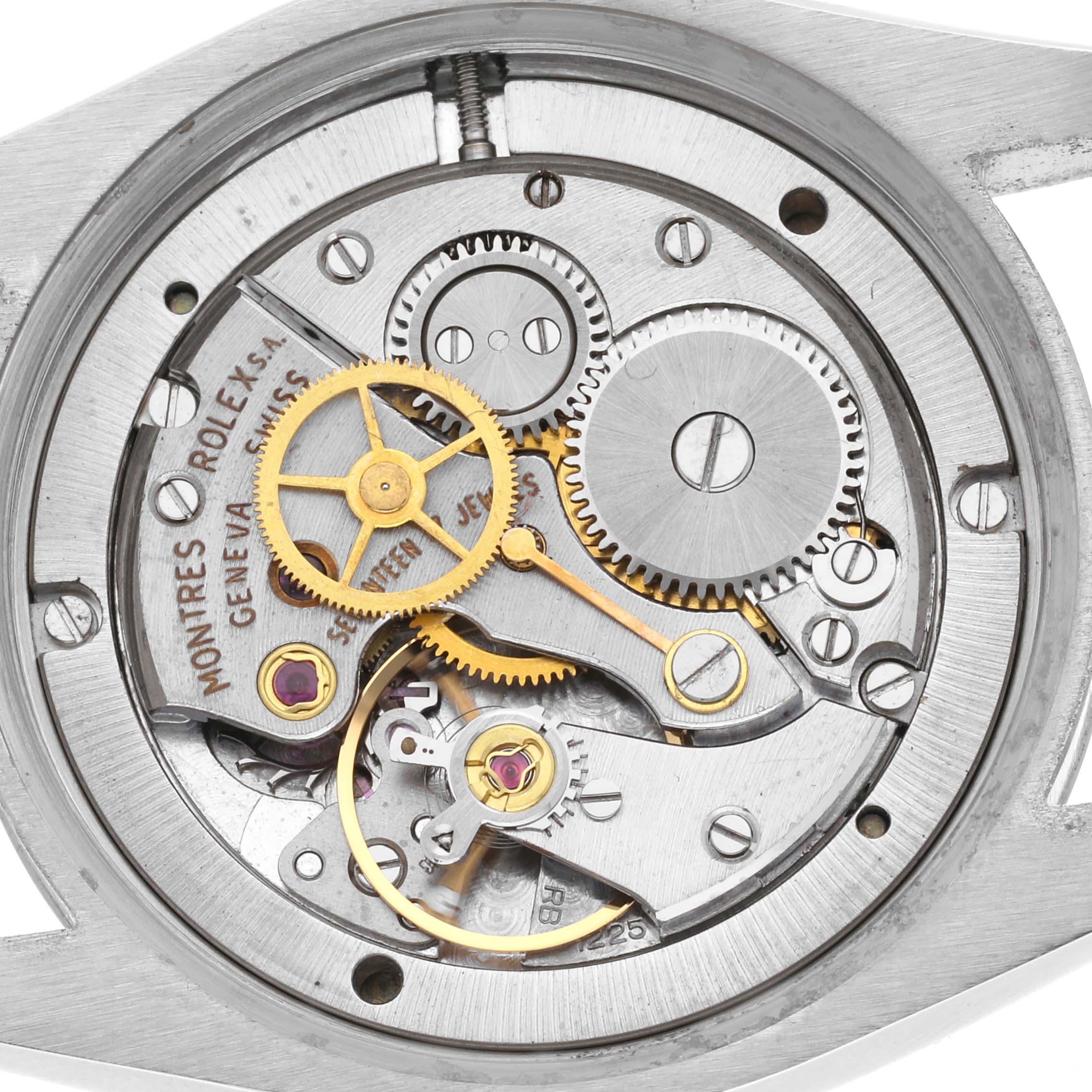 The image shows the movement of a Rolex Date 6694 Men's Stainless Steel Silver Dial 6694 Men's Stainless Steel Silver Dial watch from a top-down angle, highlighting gears and mechanical components.