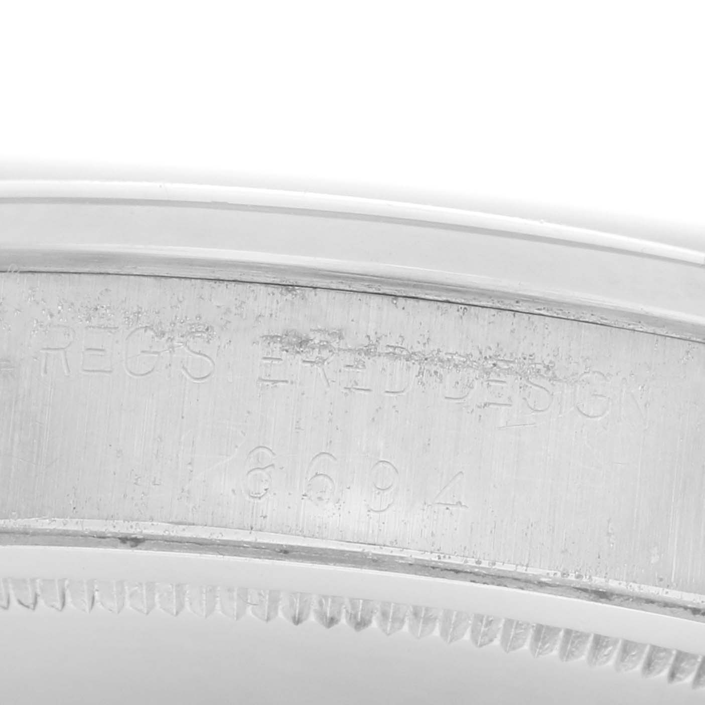 The image shows a close-up view of the inner bezel with engravings on the Rolex Date 6694 Men's Stainless Steel Silver Dial 6694 Men's Stainless Steel Silver Dial model watch.