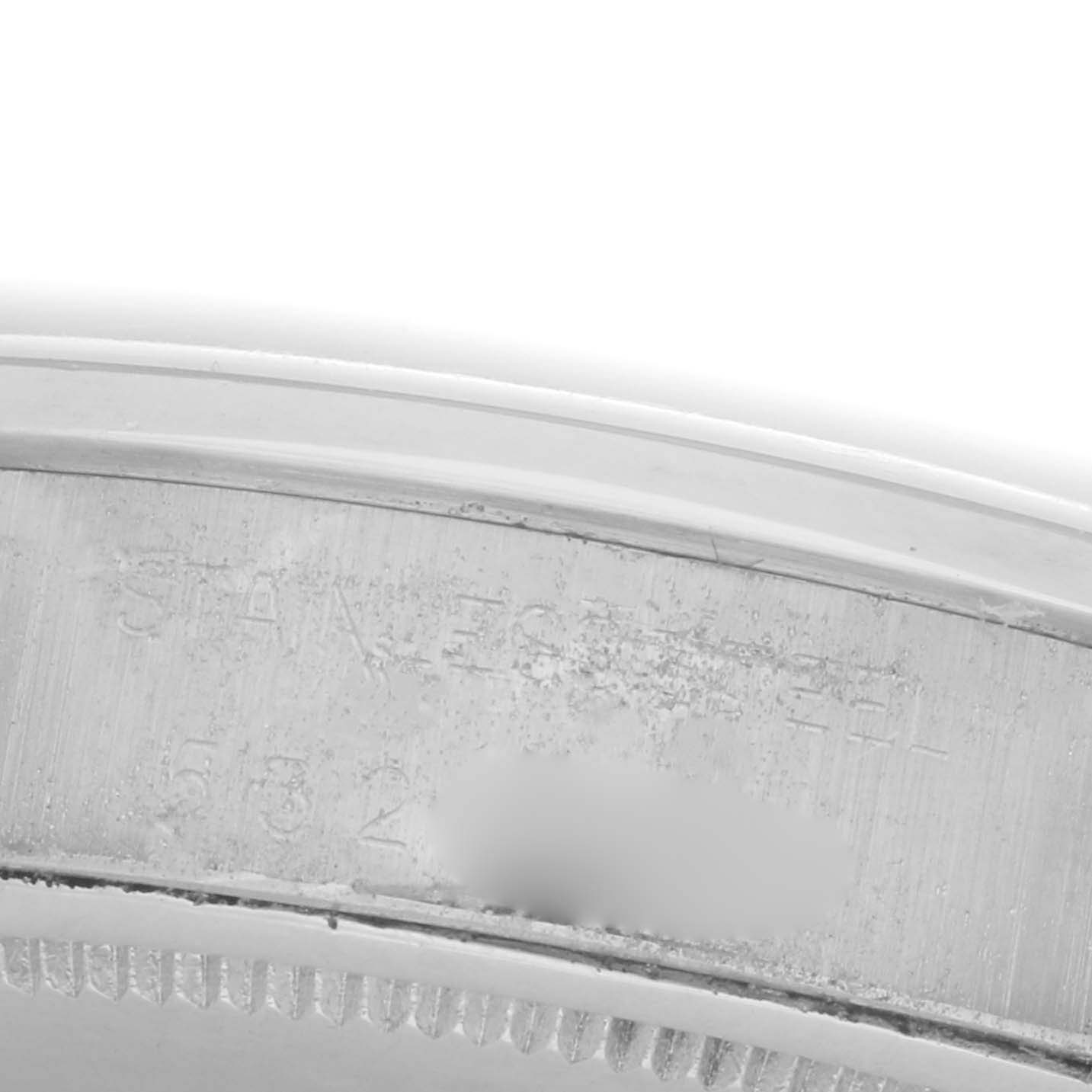 The image shows a close-up of the inner bezel and part of the case of a Rolex Date 6694 Men's Stainless Steel Silver Dial 6694 Men's Stainless Steel Silver Dial watch.