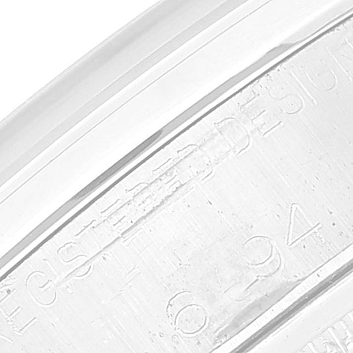 This close-up image shows the serial number and part of the case of a Rolex Vintage Collection 6694 Men's Stainless Steel Silver Dial 6694 Men's Stainless Steel Silver Dial watch.