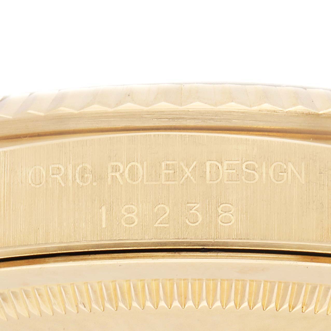 This image shows a close-up of the Rolex President 18238 Men's Yellow Gold Champagne Dial 18238 Men's Yellow Gold Champagne Dial model's case edge, detailing the engraved model number "18238."