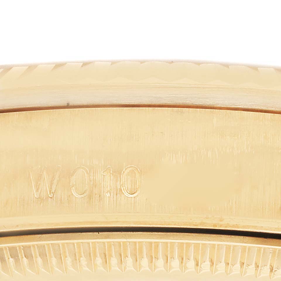 This image shows a close-up of the side of a Rolex President 68238 Women's Yellow Gold Champagne Dial 68238 Women's Yellow Gold Champagne Dial model, focusing on the engraved serial number.