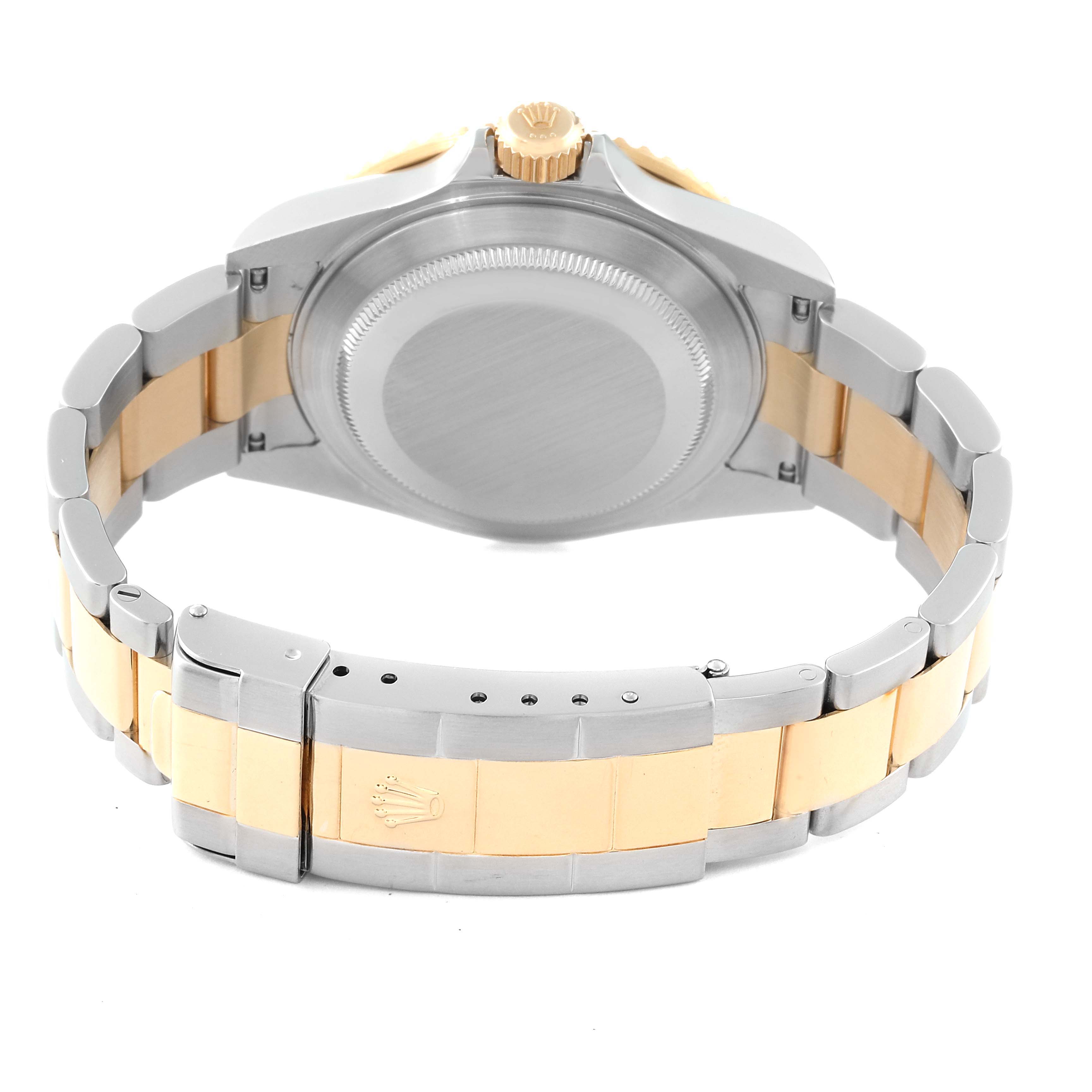 This image shows the back view of a Rolex Submariner 16613 Men's Steel and Gold (two tone) Black Dial 16613 Men's Steel and Gold (two tone) Black Dial watch, highlighting the case, crown, and two-tone metal bracelet clasp.