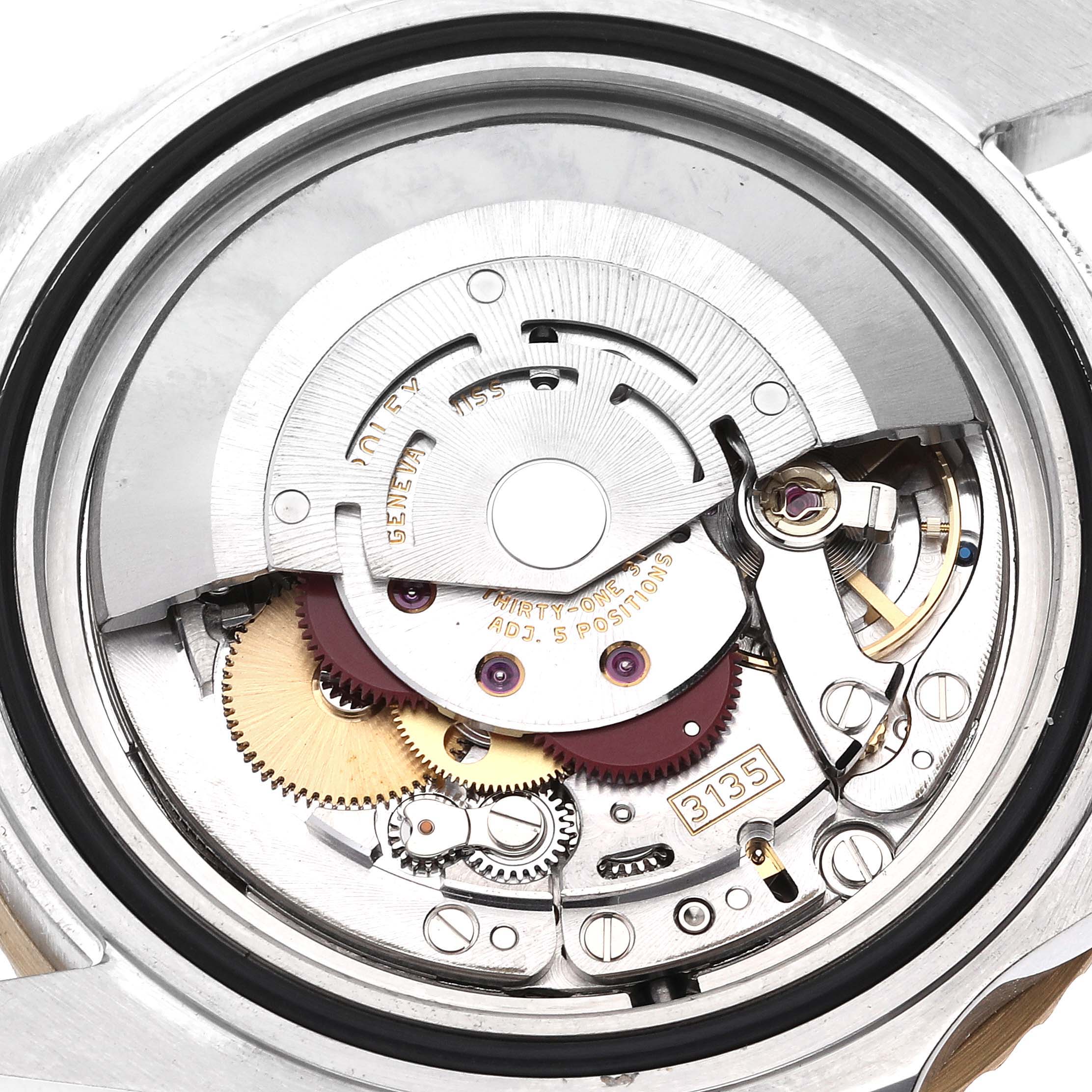 The image shows an internal view of the Rolex Submariner 16613 Men's Steel and Gold (two tone) Black Dial 16613 Men's Steel and Gold (two tone) Black Dial watch mechanism, focusing on the movement and gears.