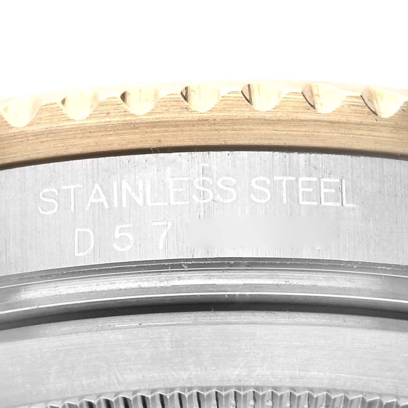 This image shows a close-up of the stainless steel caseback and part of the bezel of a Rolex Submariner 16613 Men's Steel and Gold (two tone) Black Dial 16613 Men's Steel and Gold (two tone) Black Dial watch.