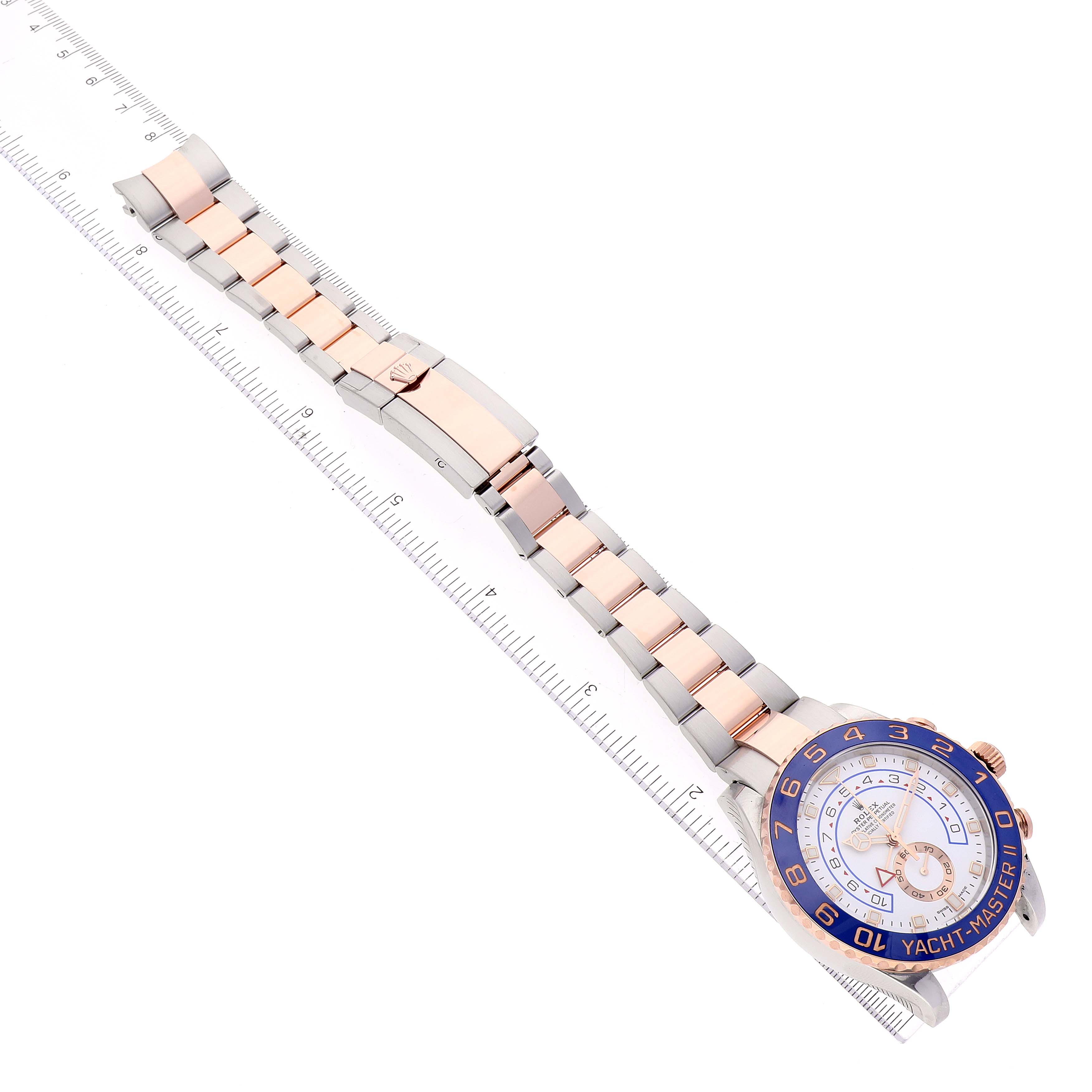 This image shows an overhead view of a Rolex Yacht-Master 116681 Men
s Steel and Gold (two tone) White Dial 116681 Men
s Steel and Gold (two tone) White Dial watch, highlighting the face and full bracelet against a ruler for scale.