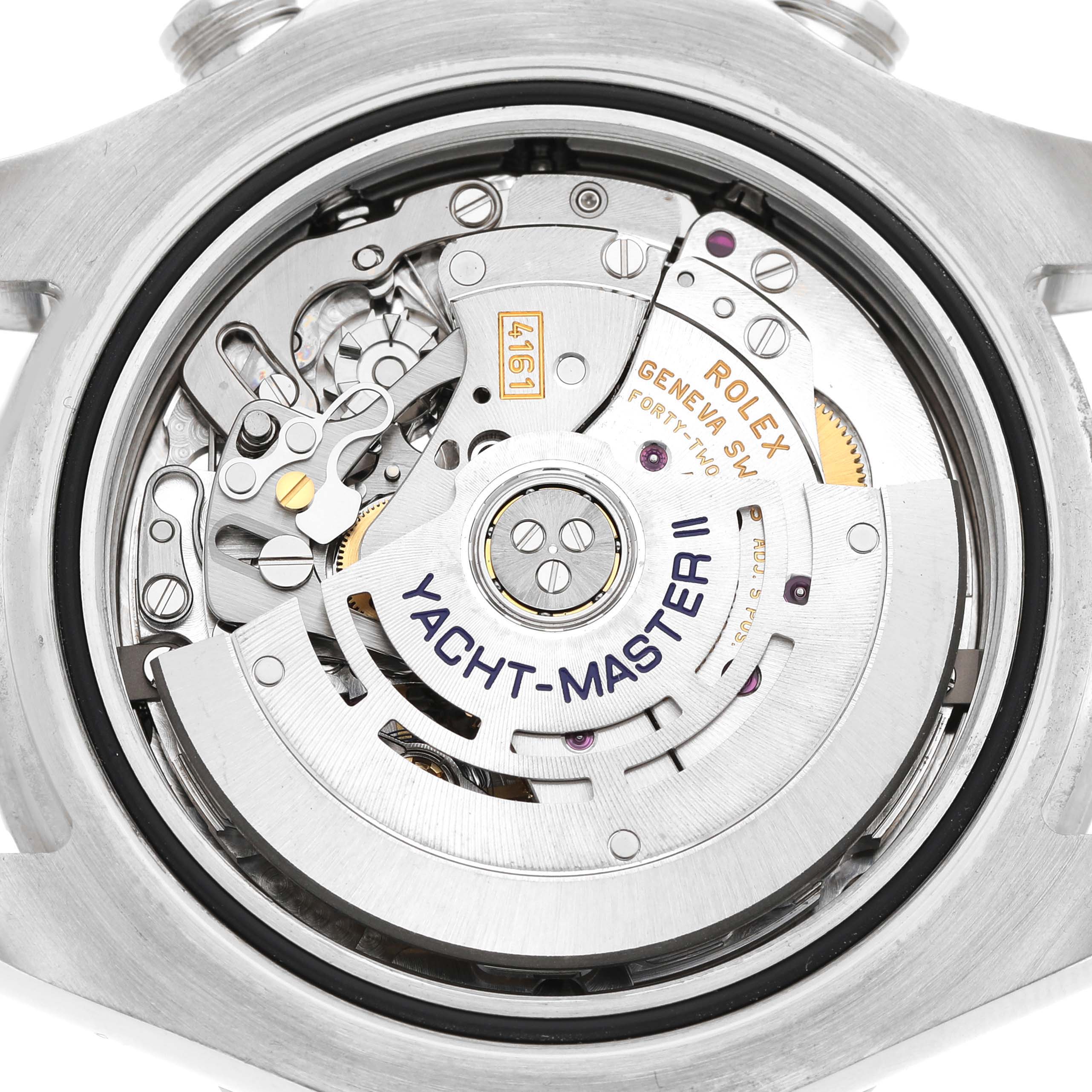 The image shows the movement mechanism of a Rolex Yacht-Master 116680 Men's Stainless Steel White Dial watch from the back angle, highlighting the rotor and intricate components.
