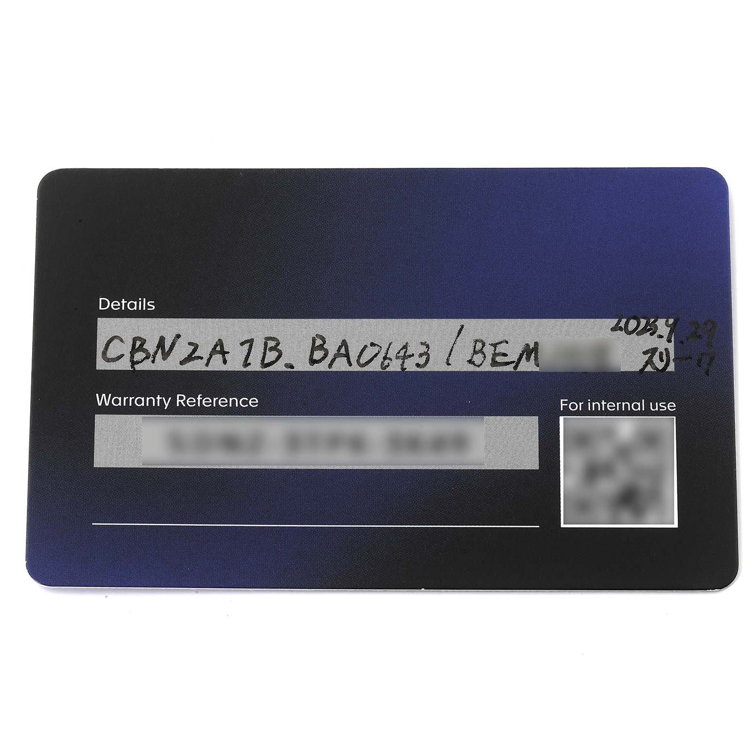 This image shows the warranty card for a Tag Heuer Carrera CBN2A1B.BA0643 Men's Stainless Steel Black Dial CBN2A1B.BA0643 Men's Stainless Steel Black Dial model watch, shot from a top-down angle.