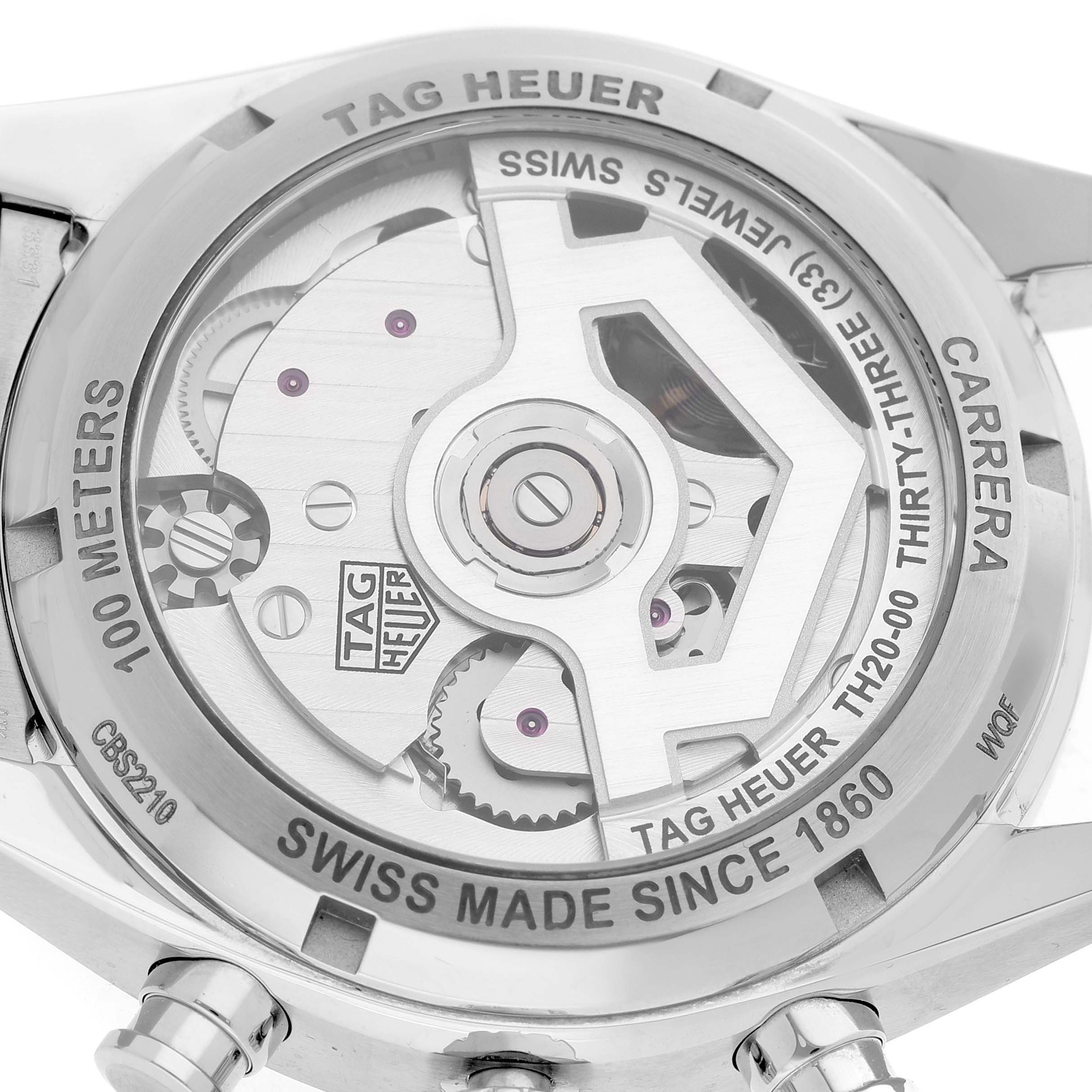 The image shows the back view of a Tag Heuer Carrera CBS2210.FC6534 Men's Stainless Steel Black Dial watch, highlighting its exposed movement and engravings.