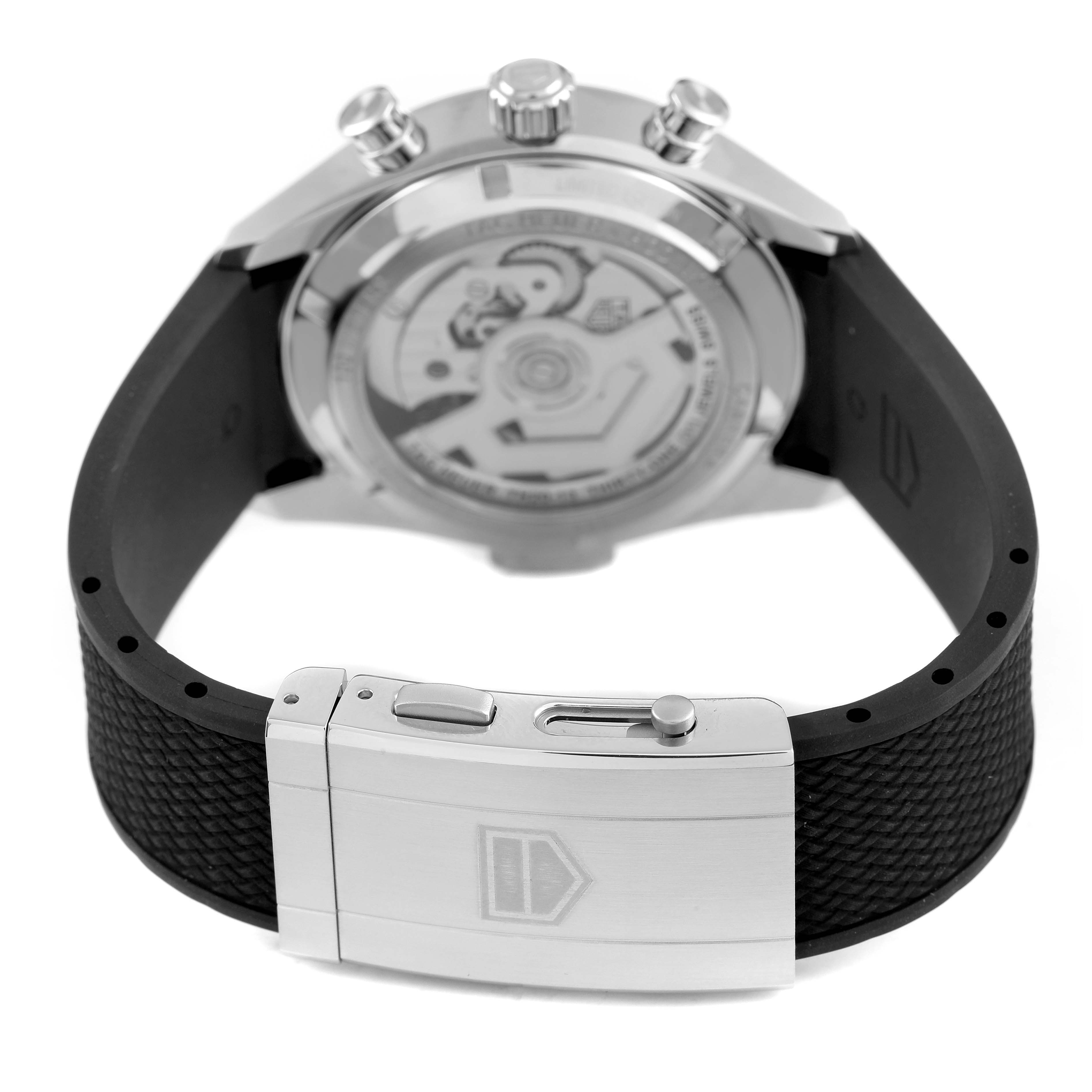 The image shows the back of the Tag Heuer Carrera CBS2014.FT6293 Men's Stainless Steel Black Dial watch, highlighting the case back, movement, and clasp on the strap.