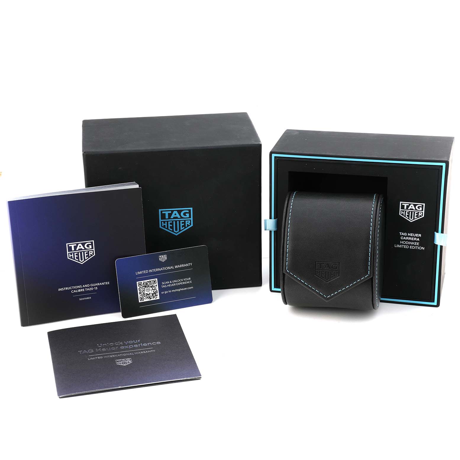 The image shows the packaging and accessories for the Tag Heuer Carrera CBS2014.FT6293 Men's Stainless Steel Black Dial, including a box, pouch, and warranty cards.