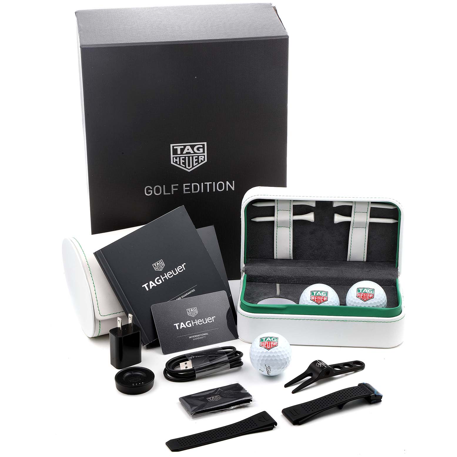 The image shows Tag Heuer Connected SBG8A82.EB0206 Men's Titanium  SBG8A82.EB0206 Men's Titanium  Golf Edition watch accessories, including a charger, cables, manuals, golf balls, and straps.