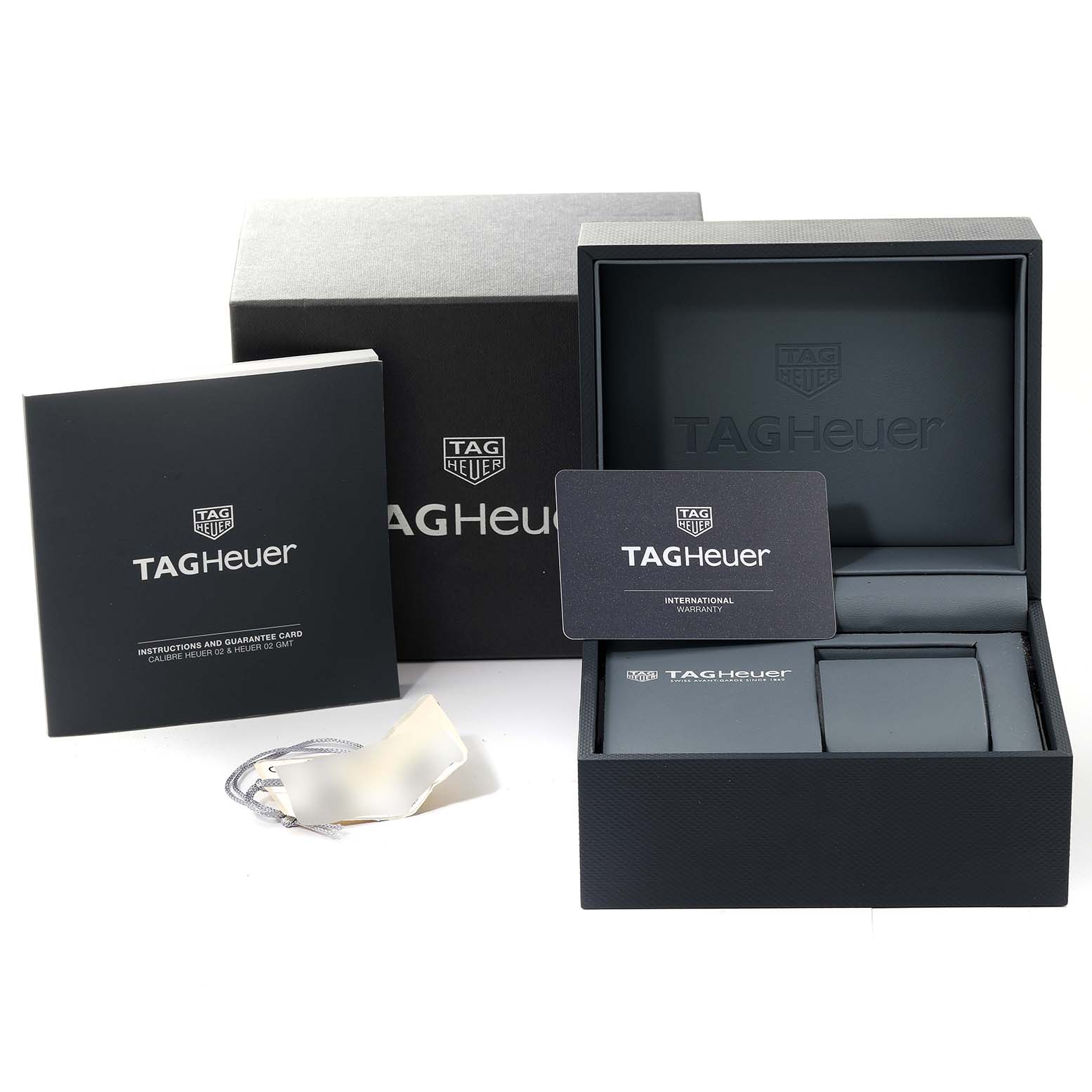 This image shows the packaging, warranty card, instruction booklet, and empty box for a Tag Heuer Monaco CBL2113.BA0644 Men's Stainless Steel Black Dial CBL2113.BA0644 Men's Stainless Steel Black Dial watch.