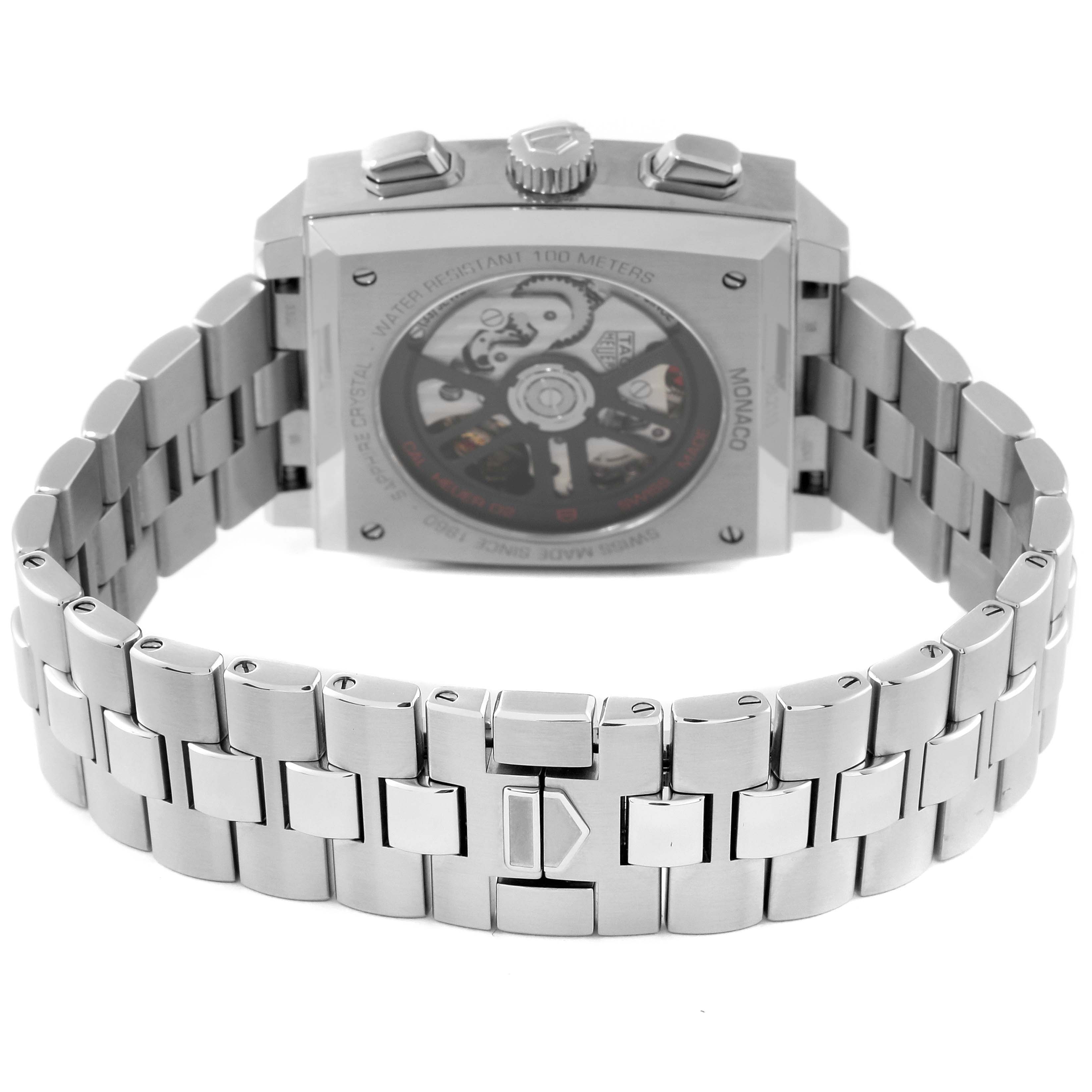 The image shows the back view of a Tag Heuer Monaco CBL2113.BA0644 Men's Stainless Steel Black Dial CBL2113.BA0644 Men's Stainless Steel Black Dial model watch, highlighting its metal bracelet and visible movement mechanism.