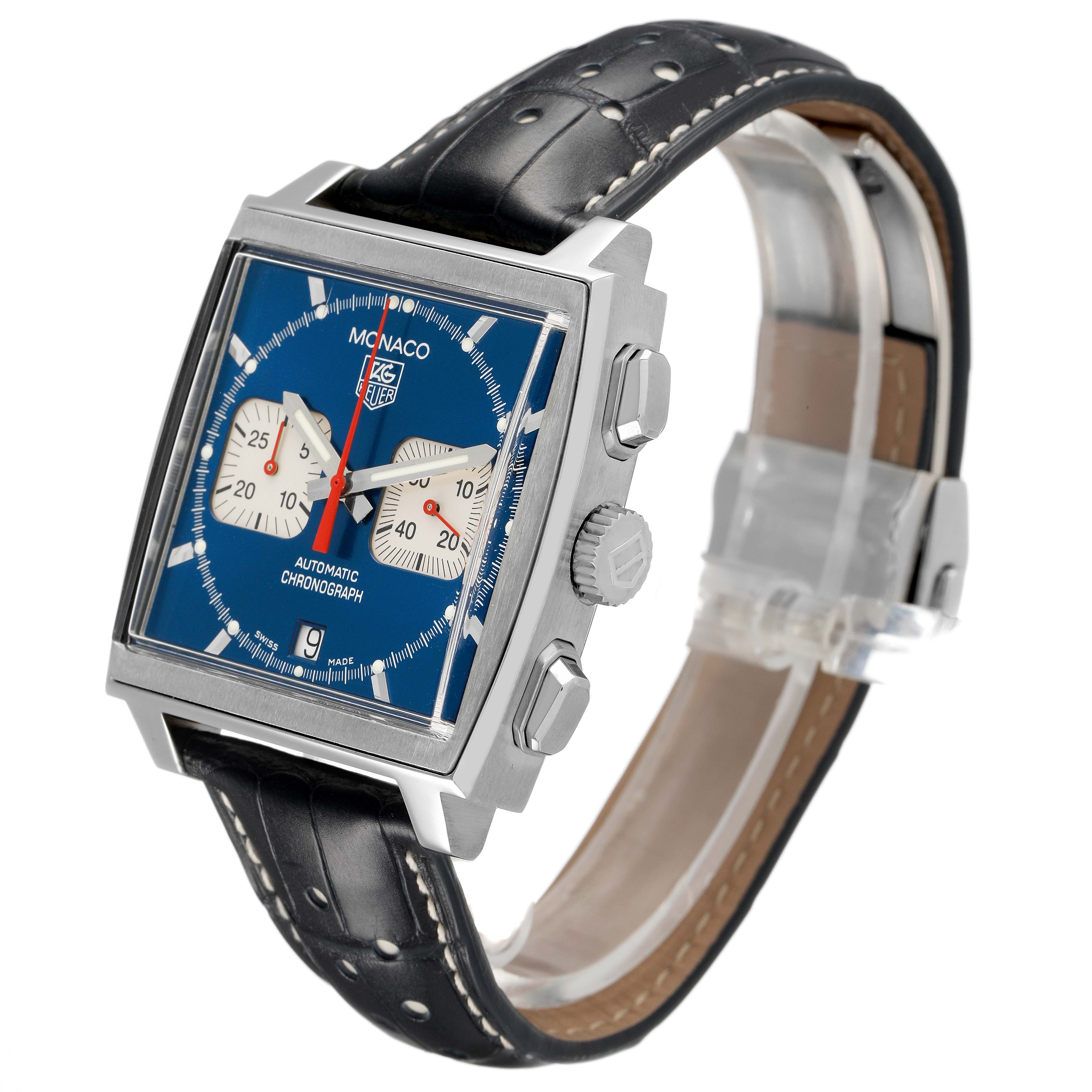 The Tag Heuer Monaco CW2113 Men's Stainless Steel Blue Dial watch is shown at a three-quarter angle, highlighting the square blue dial, side crown, and black leather strap.