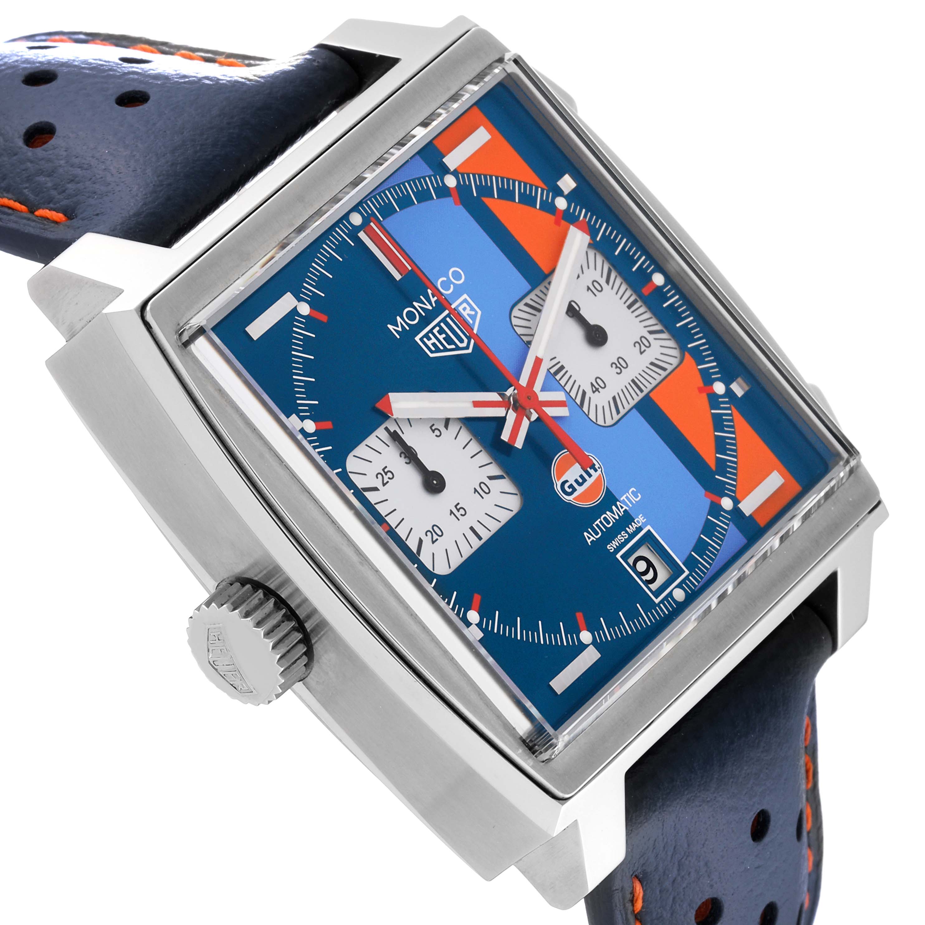 The Monaco model by Tag Heuer is shown at a front angle, highlighting the square face, blue dial, and perforated strap.