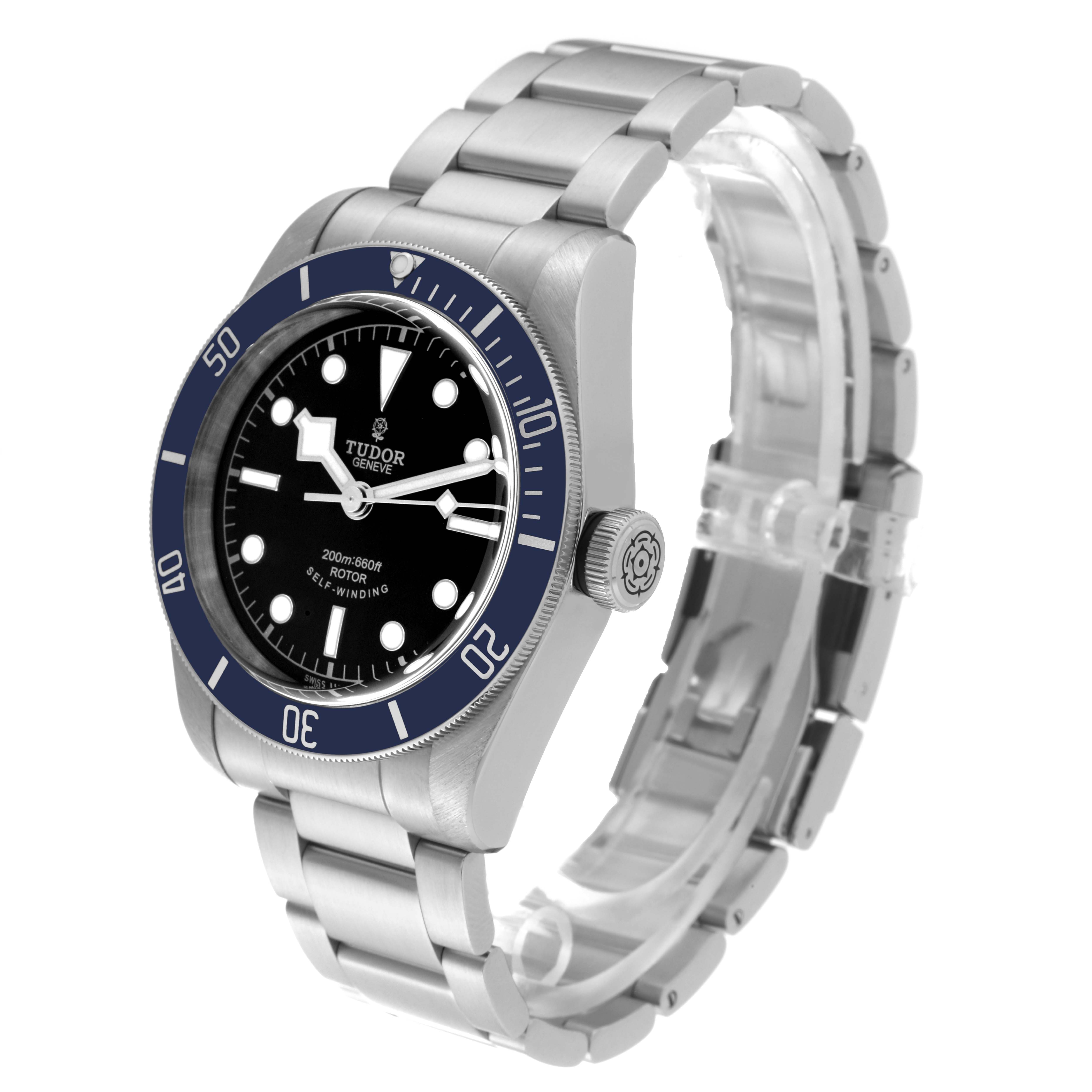 The Tudor Heritage Black Bay 79220B Men's Stainless Steel Black Dial 79220B Men's Stainless Steel Black Dial watch is shown at an angle highlighting the dial, bezel, crown, case, and part of the bracelet.