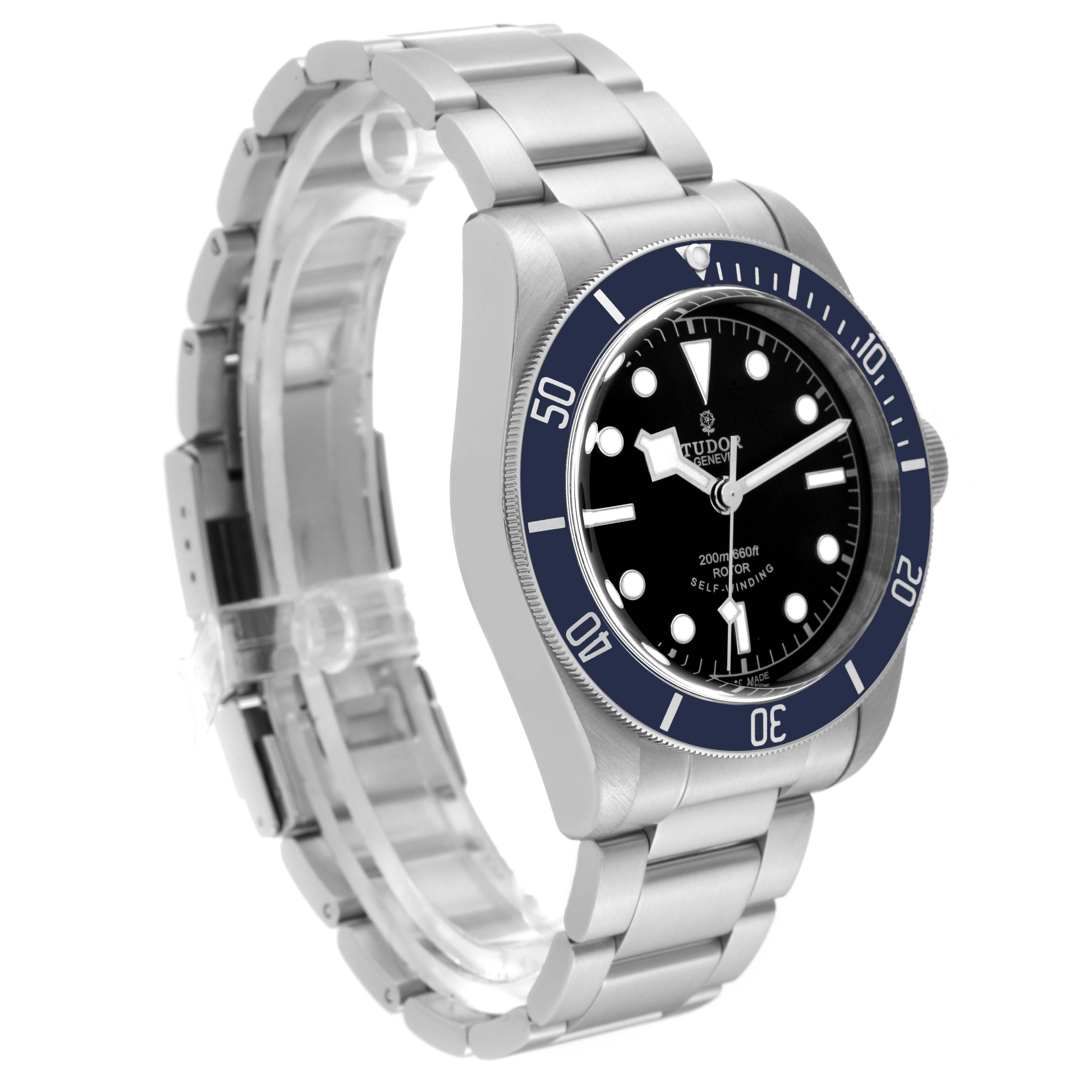 The Tudor Heritage Black Bay 79220B Men's Stainless Steel Black Dial 79220B Men's Stainless Steel Black Dial watch is shown at an oblique angle, featuring the face, bezel, crown, and bracelet.