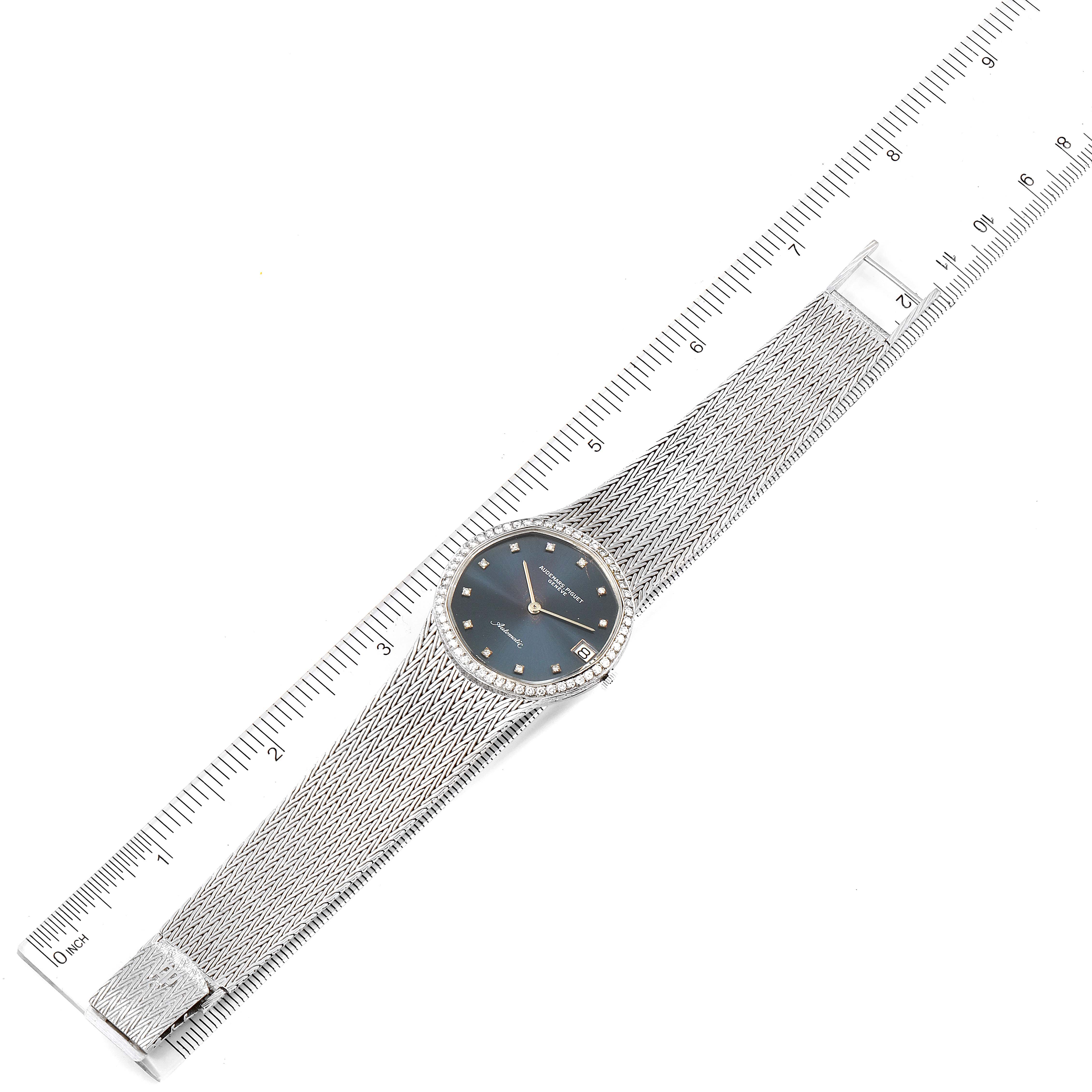 The image shows a top-down view of a Vintage Audemars Piguet watch with a mesh band next to a ruler for size reference.