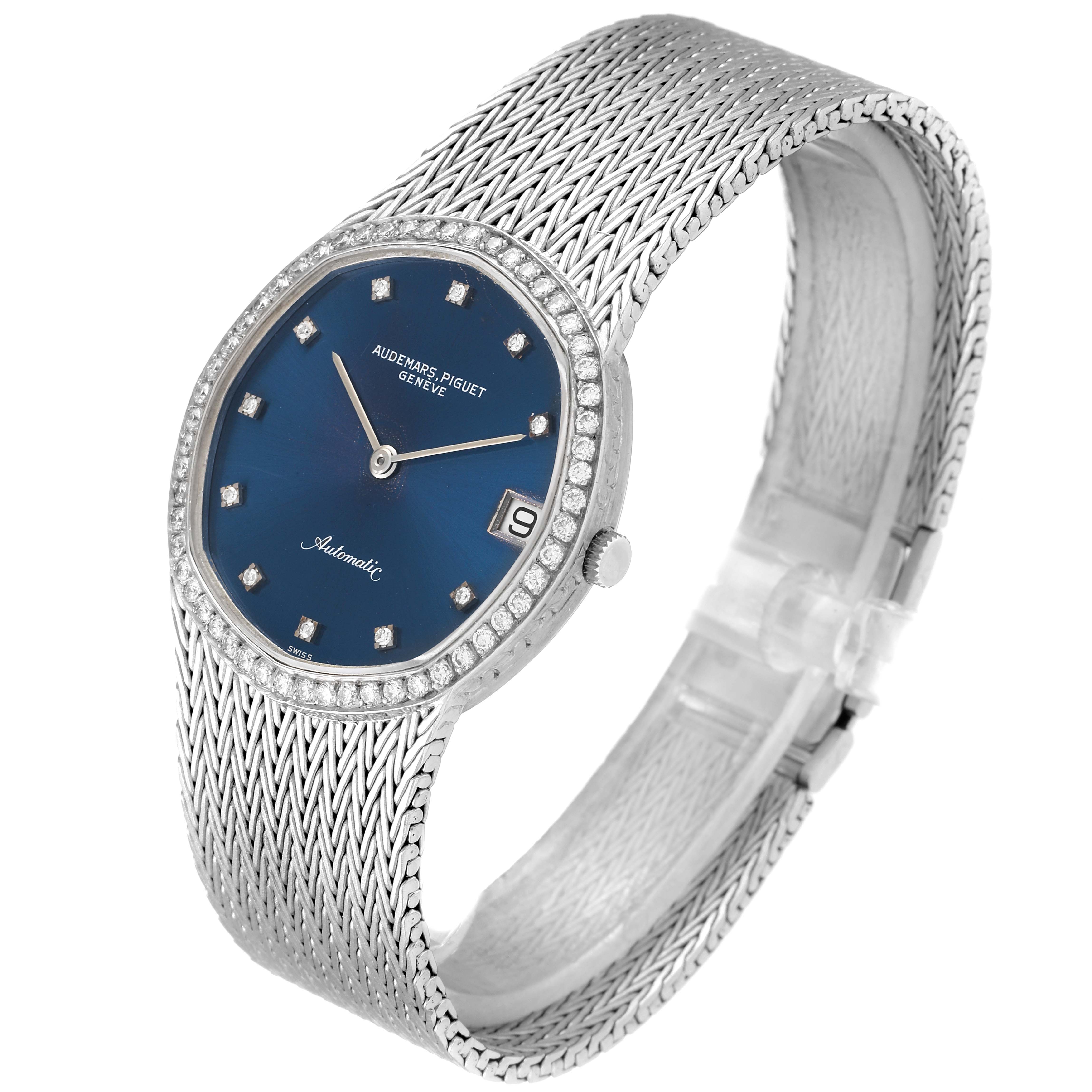 The Vintage Audemars Piguet watch is shown at a slight angle, highlighting its blue dial, diamond indices, and textured silver bracelet.