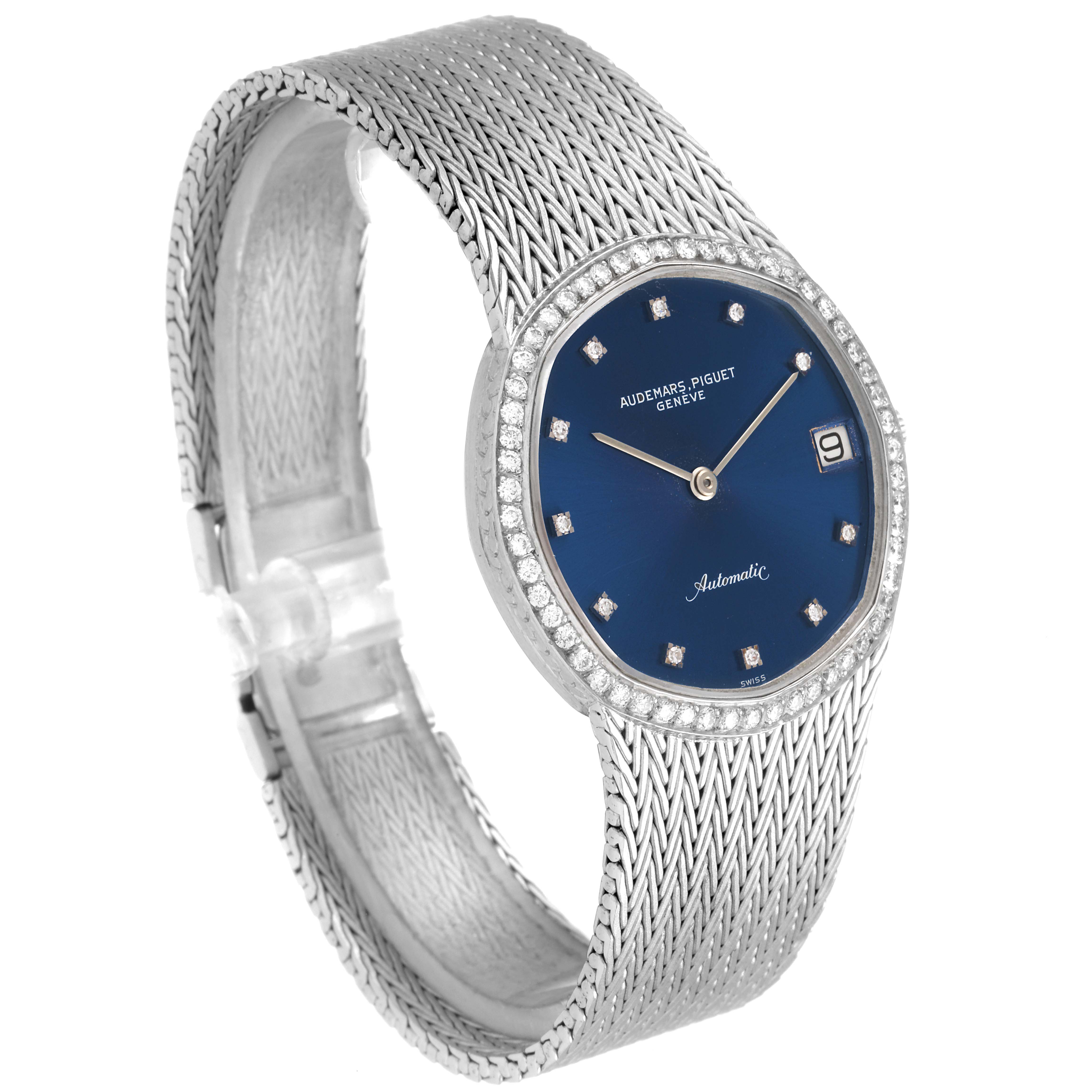 This image shows a close-up angled view of a Vintage Audemars Piguet watch with a blue dial, diamond markers, and a silver bracelet.