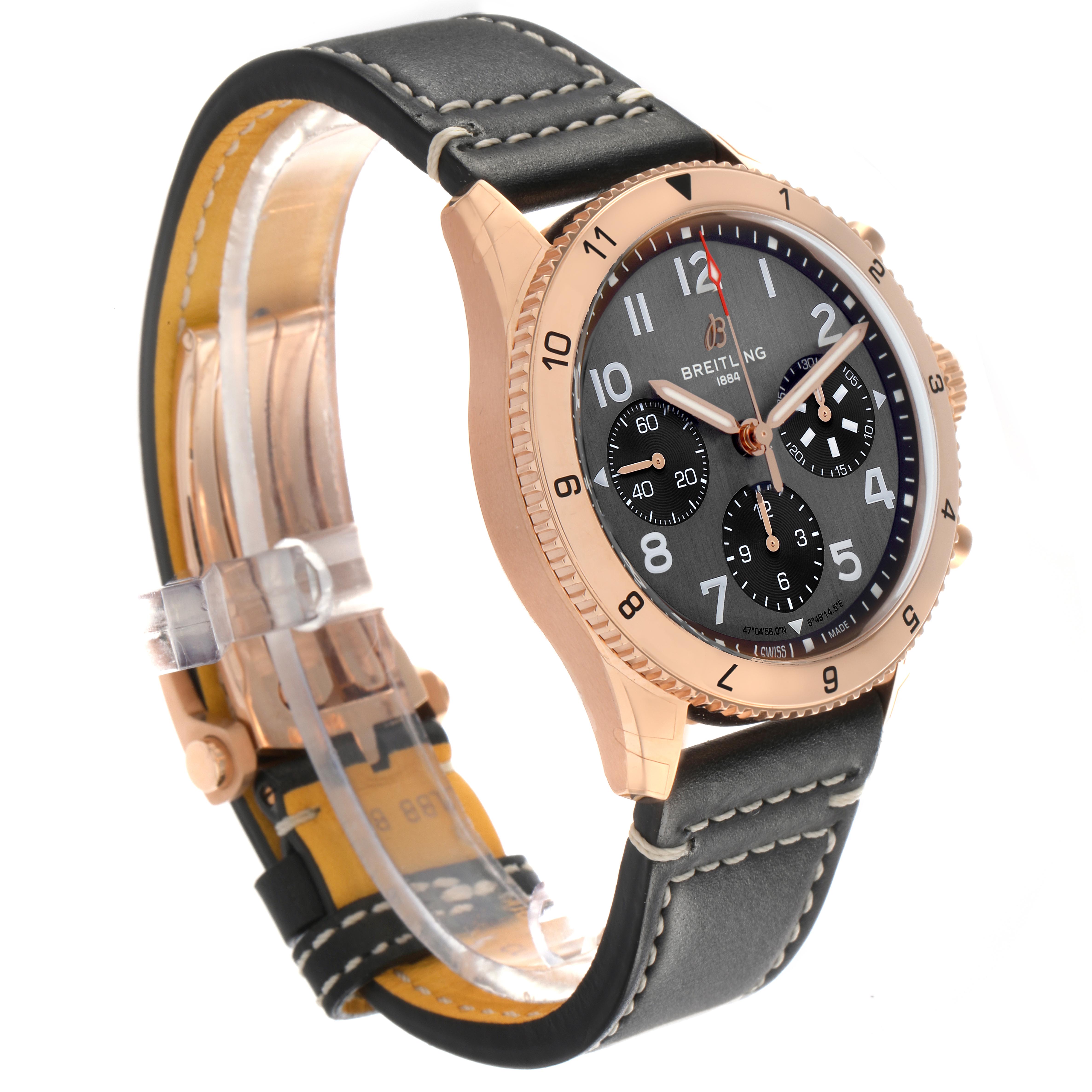 The Breitling Aviator R23380 Men's Rose Gold Grey Dial R23380 Men's Rose Gold Grey Dial watch is shown in a three-quarter angle, displaying its face, bezel, side, and black leather strap with stitching.