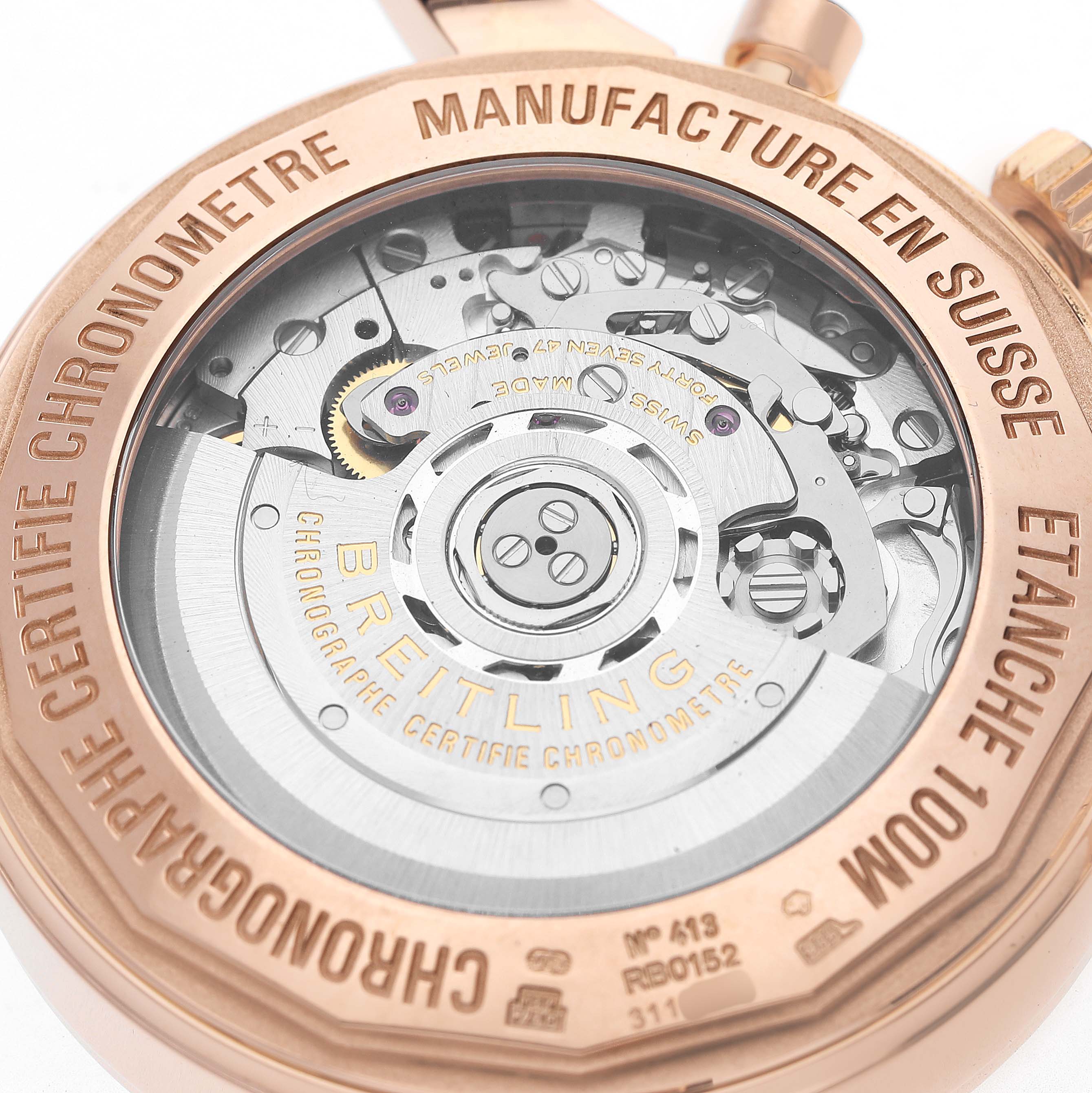 This image shows the reverse side of a Breitling Transocean RB0152 Men's Rose Gold Blue Dial watch, highlighting its exposed mechanical movement and engraving.