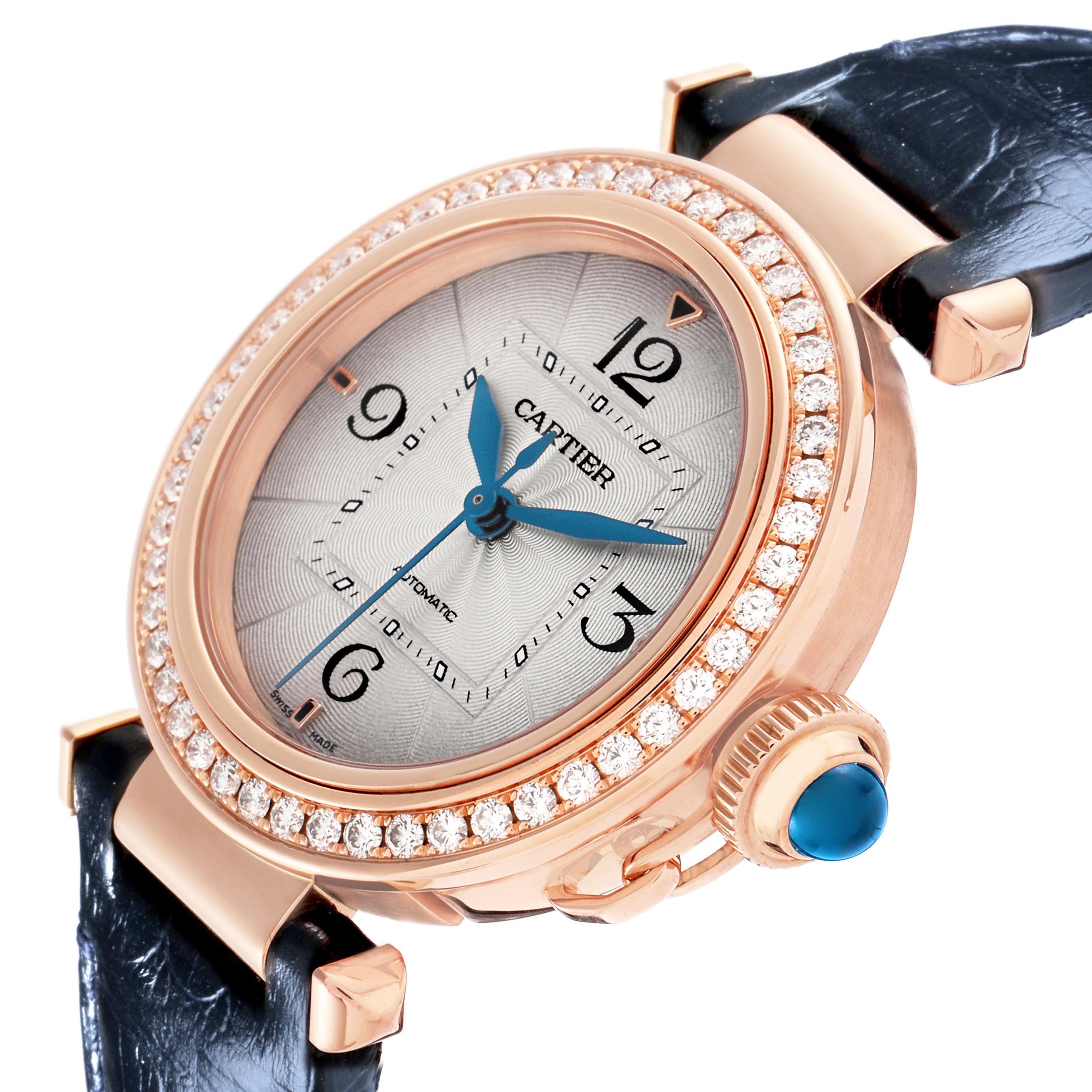 The Cartier Pasha WJPA0012 Women's Rose Gold Silver Dial watch is shown at an angled view, highlighting the front face, bezel with diamonds, crown, and strap attachment.