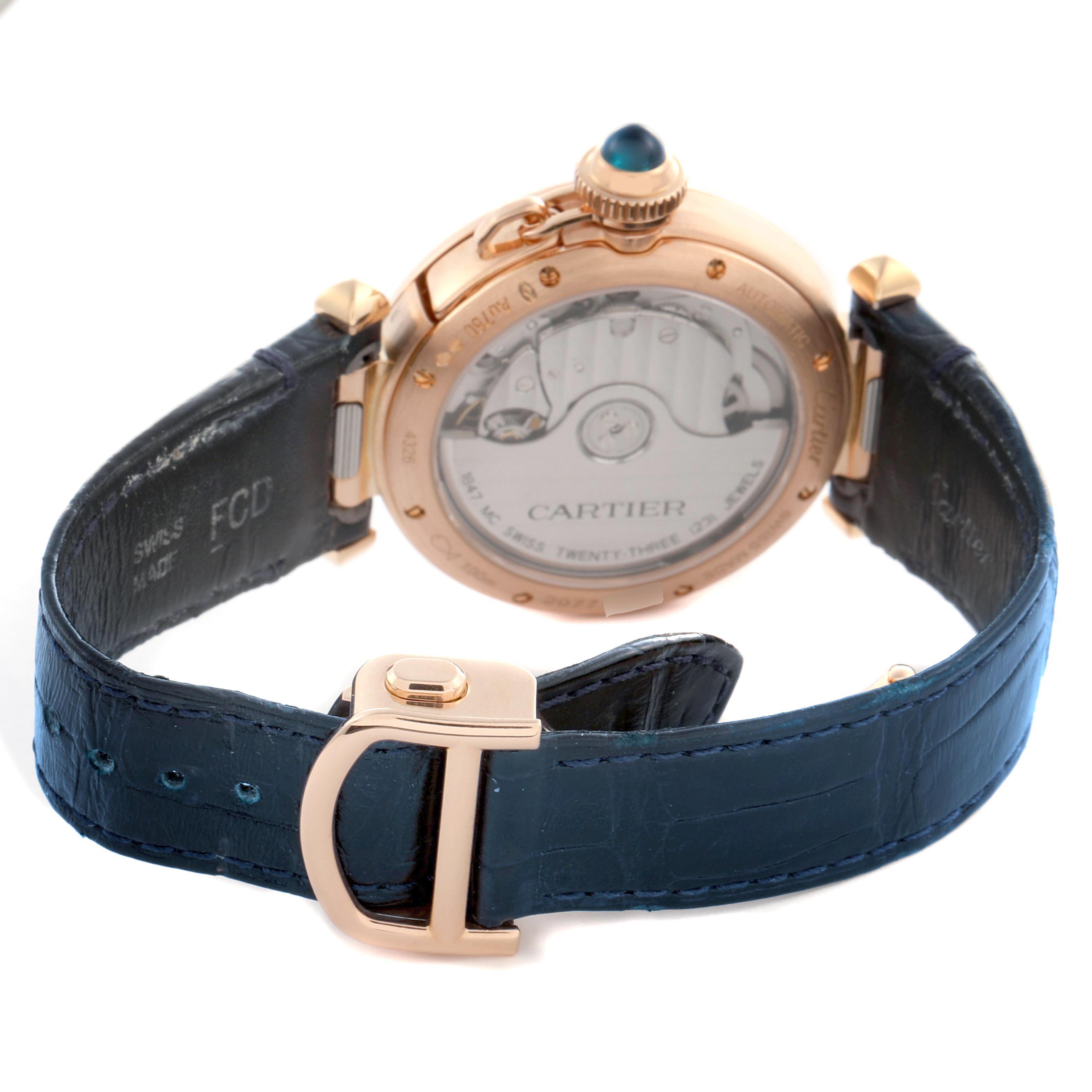 The Cartier Pasha WJPA0012 Women's Rose Gold Silver Dial watch is shown from a rear angle, displaying its open case back and blue leather strap.