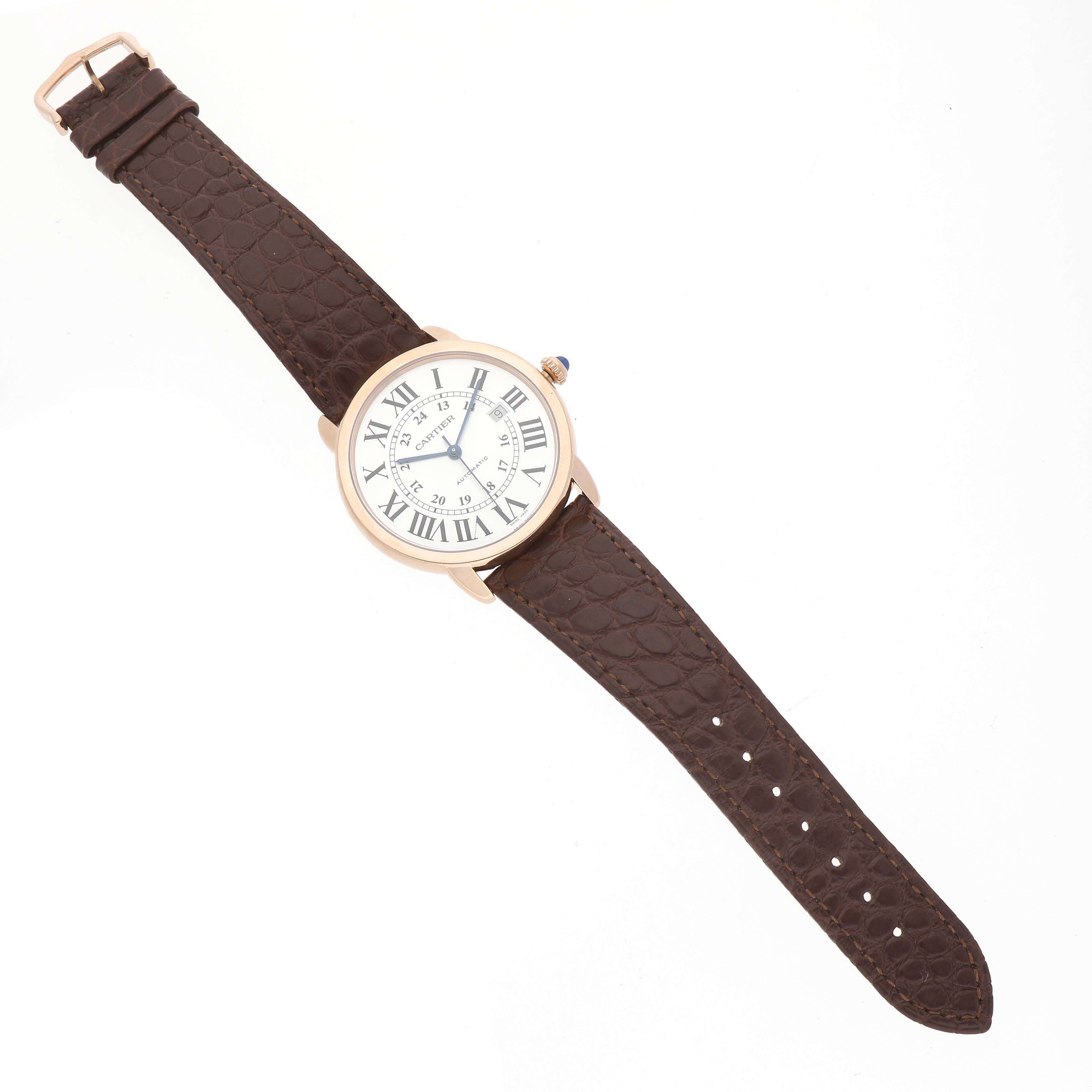 The Cartier Ronde W6701009 Men's Rose Gold Silver Dial model watch is shown from a top view, highlighting its round face, Roman numerals, and brown leather strap.