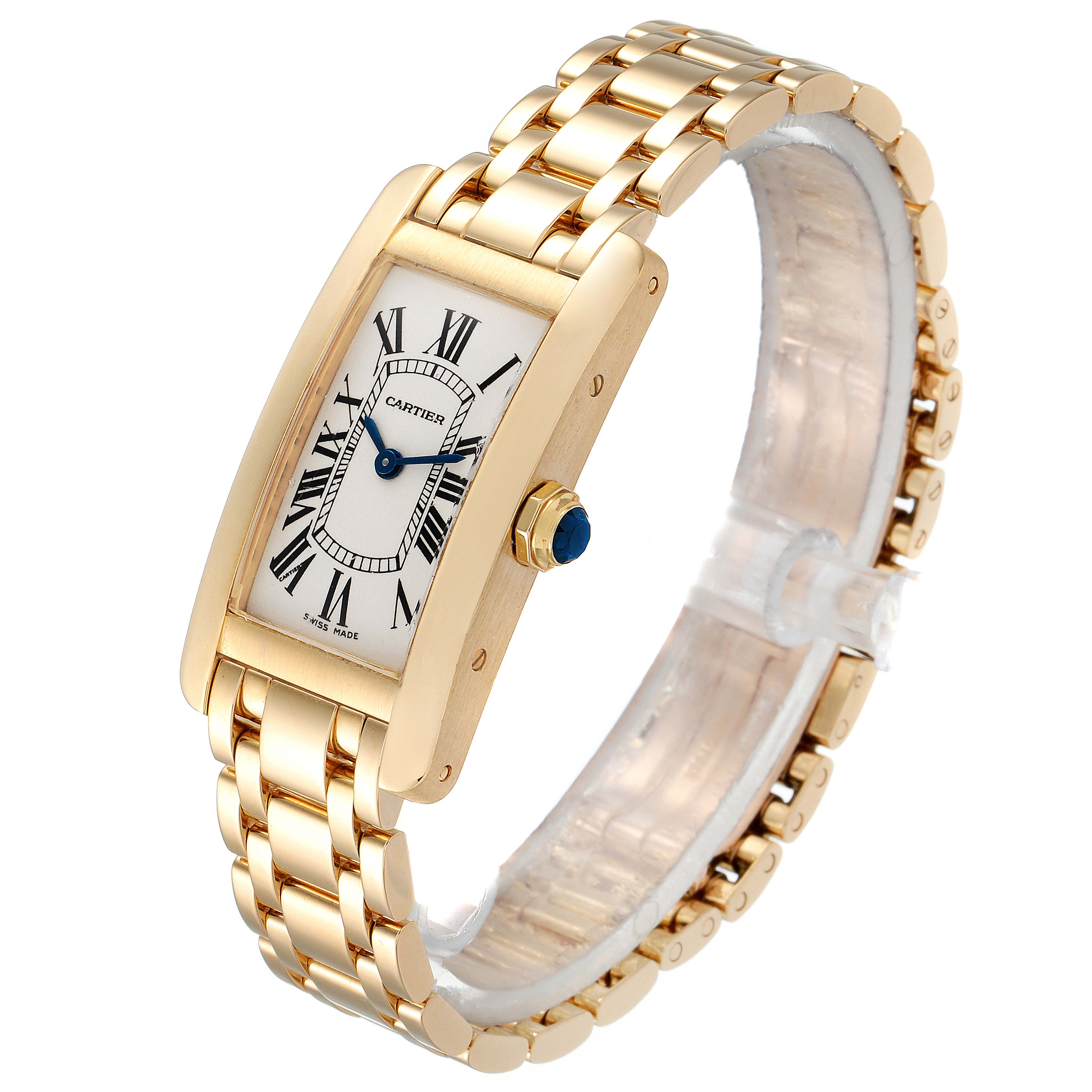 The image shows a Cartier Tank Americaine W26015K2 Women's Yellow Gold Silver Dial W26015K2 Women's Yellow Gold Silver Dial watch angled from the top and right, displaying the face, crown, and bracelet.