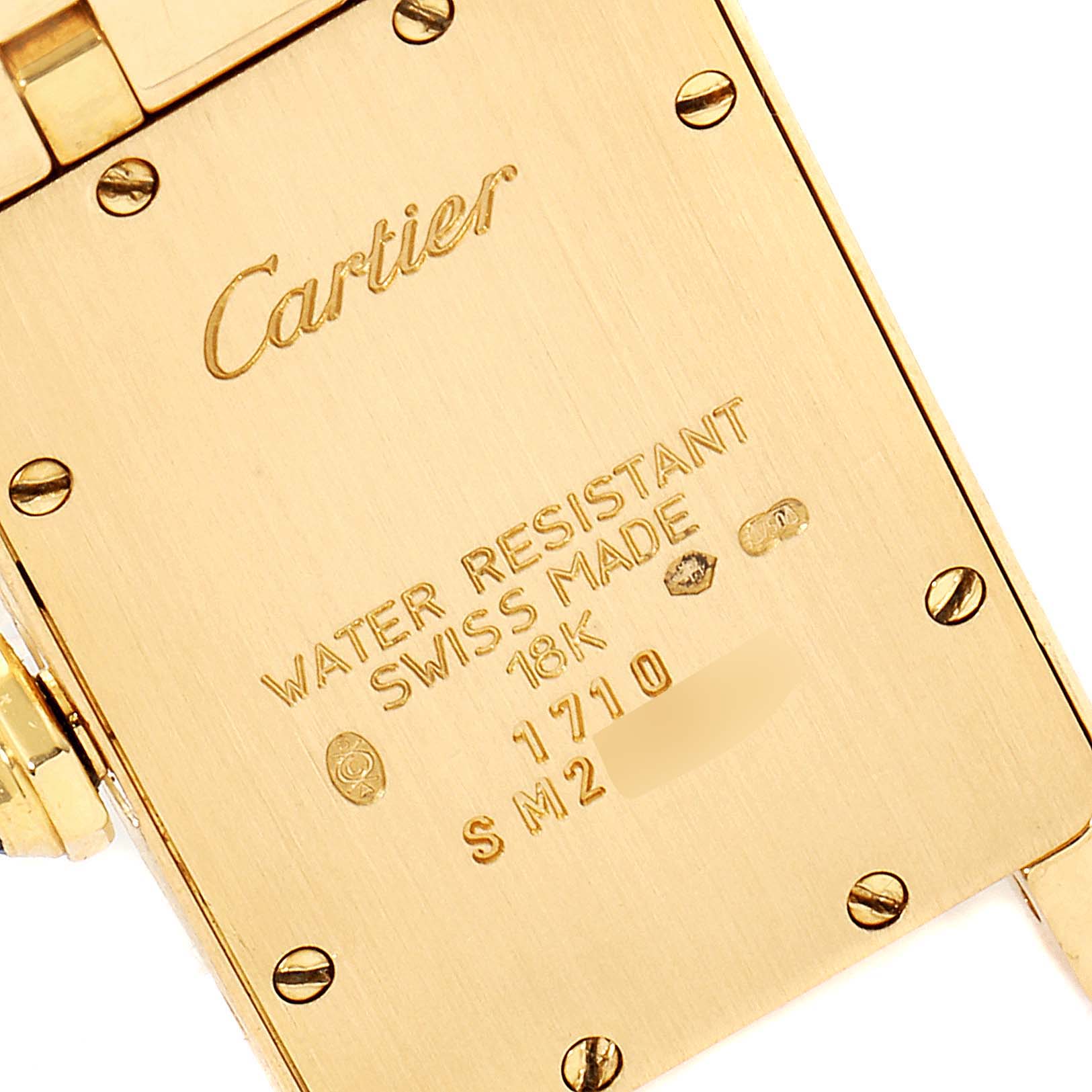 The image shows the back case of a Cartier Tank Americaine W26015K2 Women's Yellow Gold Silver Dial W26015K2 Women's Yellow Gold Silver Dial watch, highlighting the "Water Resistant," "Swiss Made," and "18K" engravings.