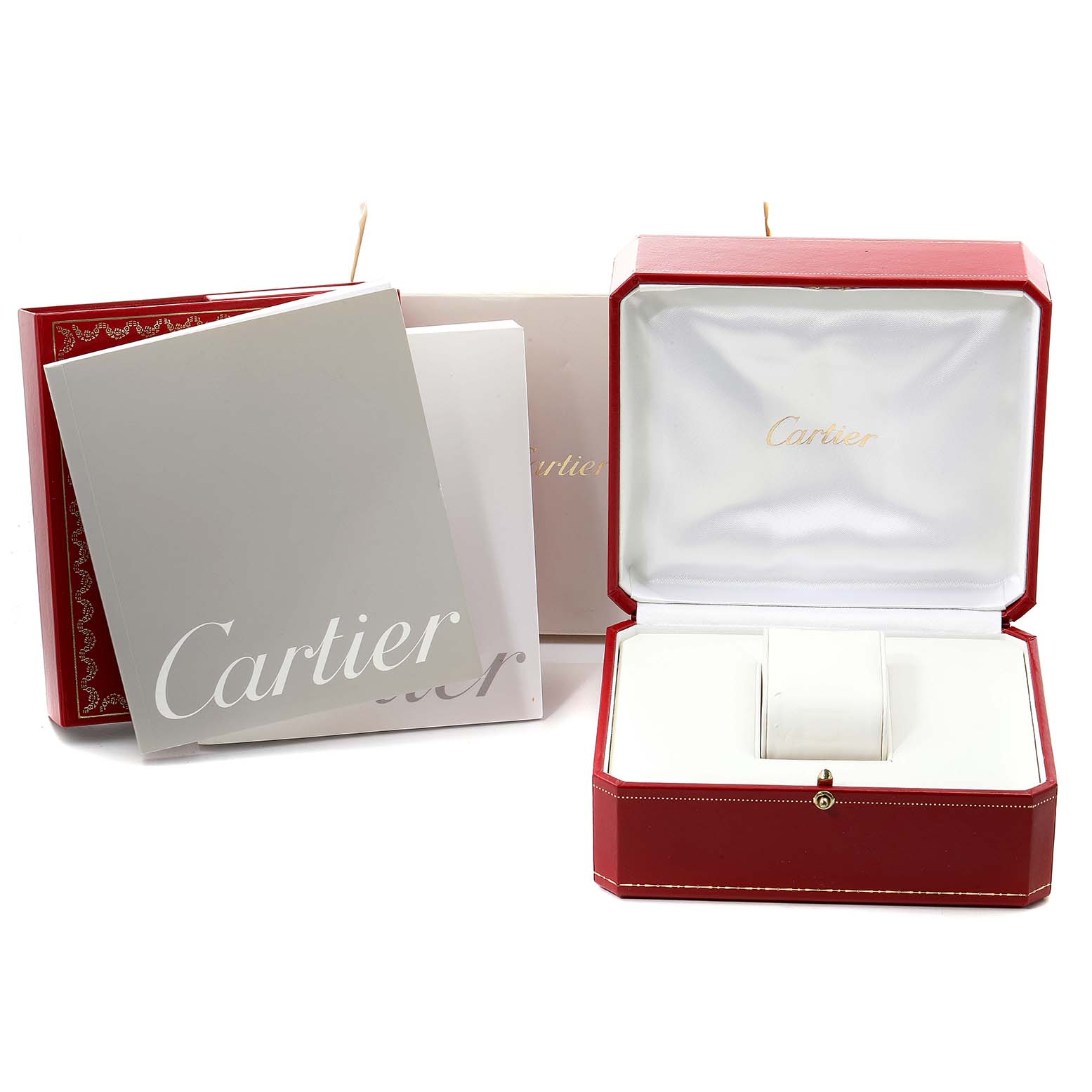 The image shows the packaging and manuals for the Cartier Tank Americaine W26015K2 Women's Yellow Gold Silver Dial W26015K2 Women's Yellow Gold Silver Dial watch, including the outer box, inner box, and booklets.