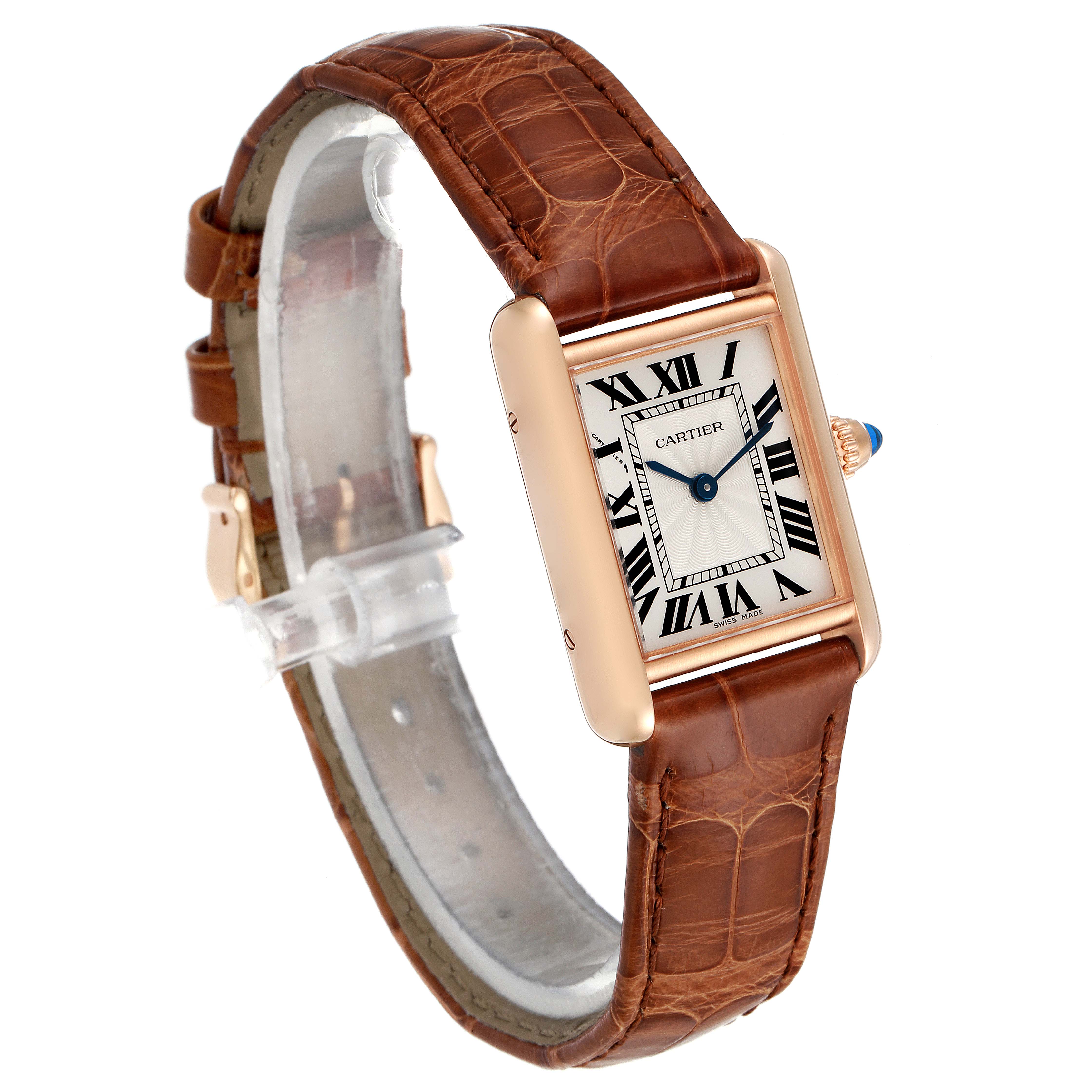The image shows a Tank Louis watch by Cartier, featuring a brown leather strap and rectangular face with Roman numerals at an angled front view.