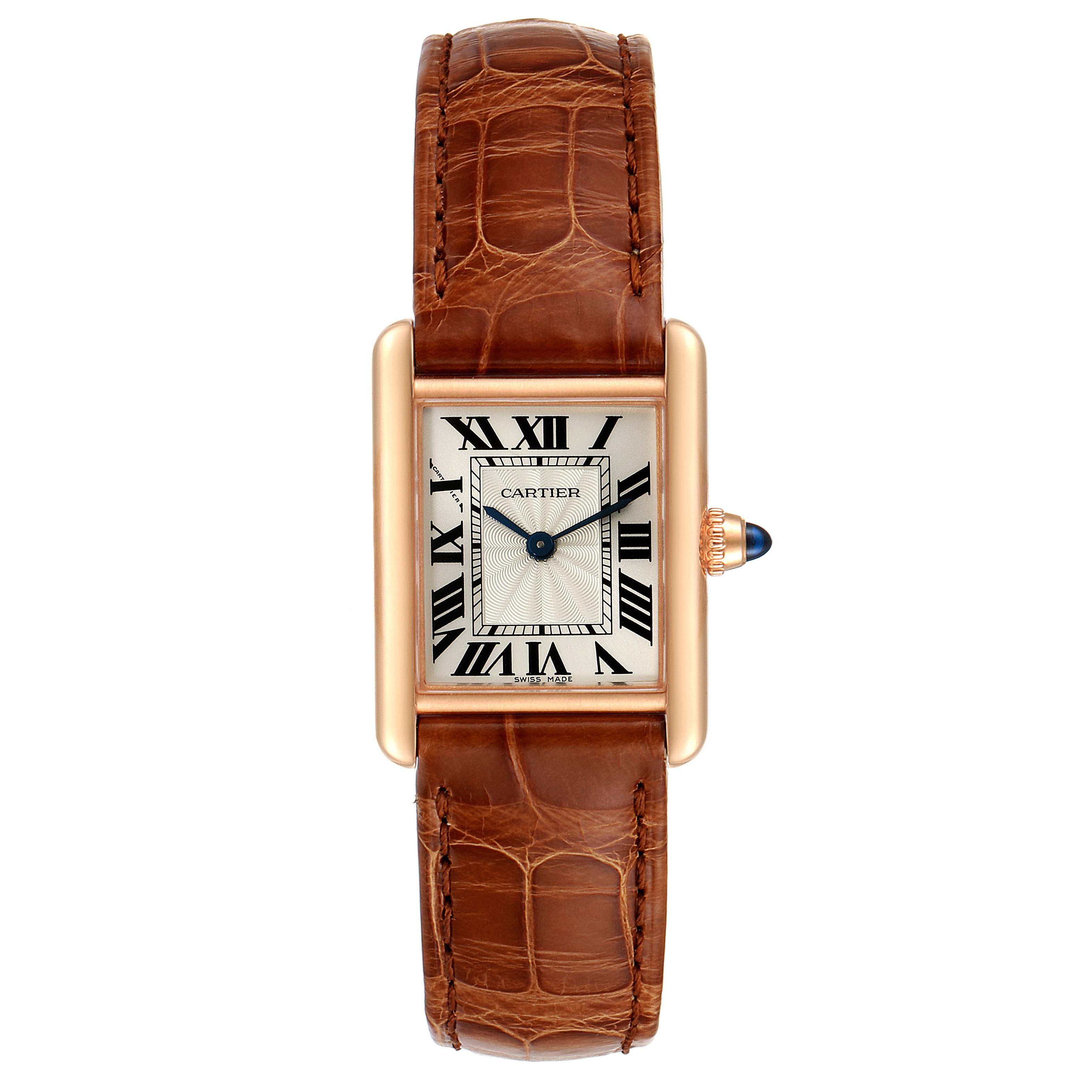 The Tank Louis by Cartier watch is shown from a top-down angle, displaying the face, bezel, and brown leather strap.