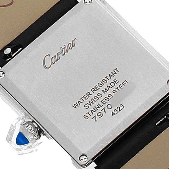 The image shows the back of the Cartier Tank Must WSTA0109 Men's Stainless Steel Silver Dial watch, displaying brand engraving and technical details.