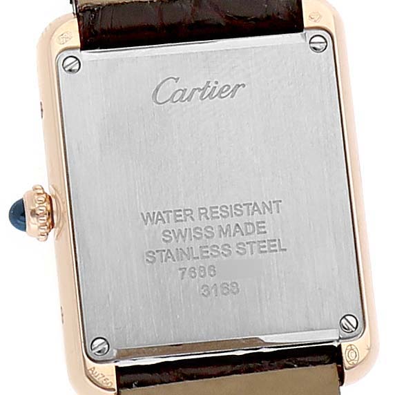 The image shows the back of a Cartier Tank Solo W5200002 Women's Yellow Gold Silver Dial watch, highlighting the caseback and crown.