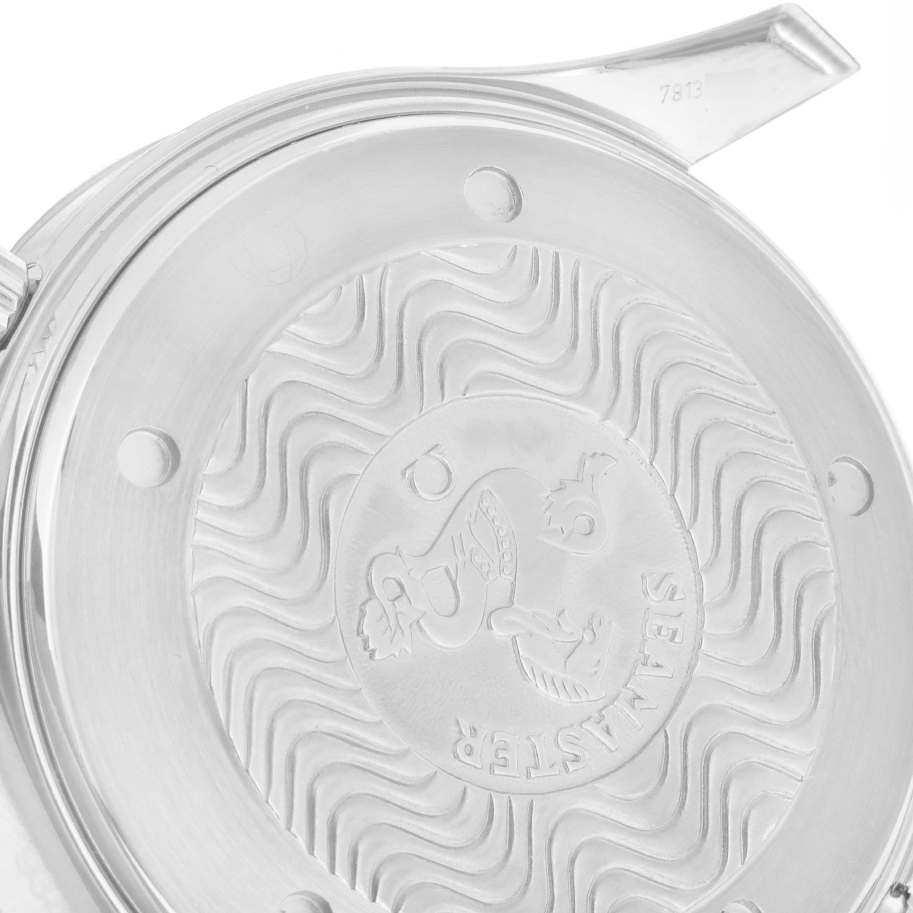 The image shows the back casing of an Omega Seamaster 2594.52.00 Men
s Stainless Steel Black Dial 2594.52.00 Men
s Stainless Steel Black Dial watch at an angle, highlighting its intricate wavy design and emblem.