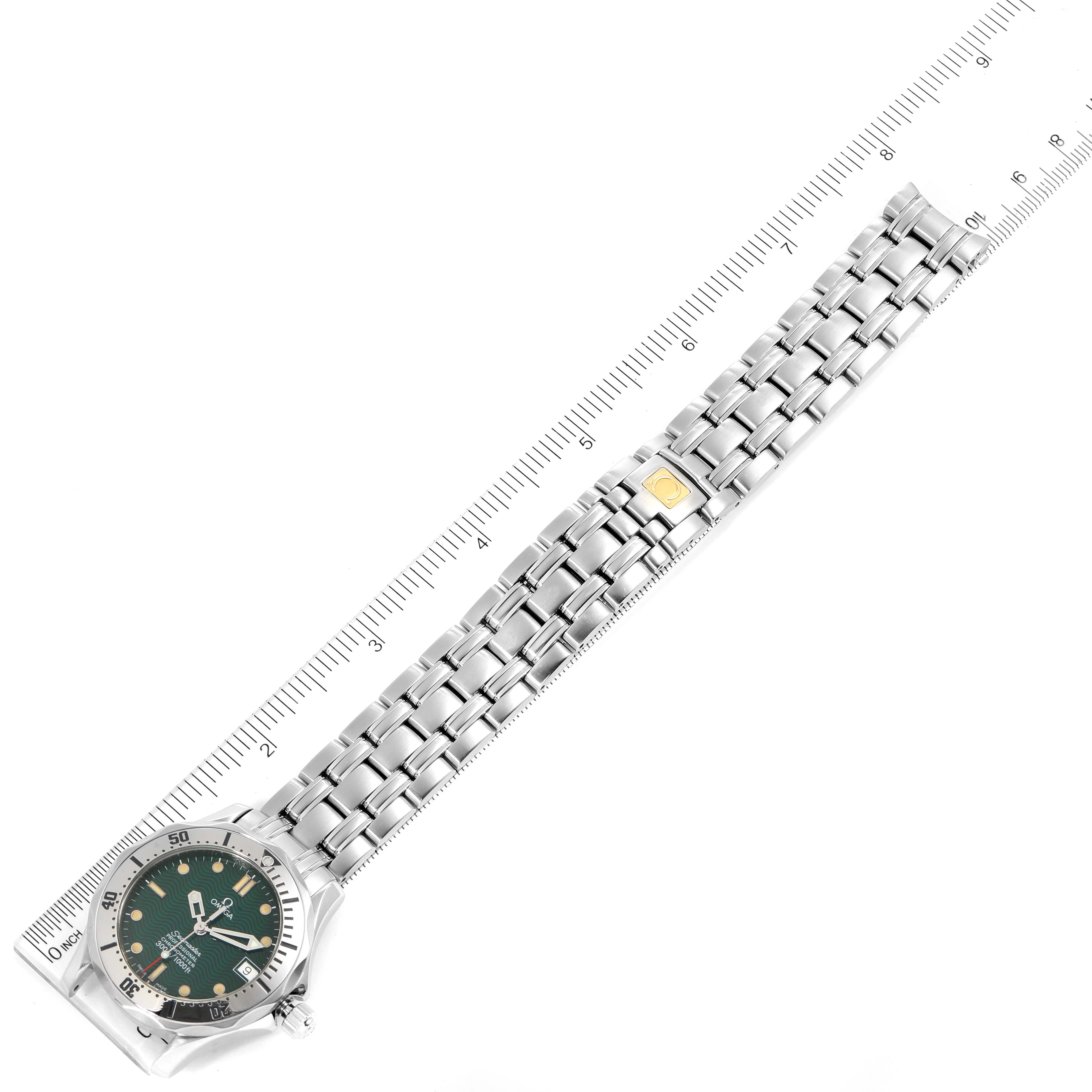 The image shows an Omega Seamaster 2553.41.00 Men's Stainless Steel Green Dial 2553.41.00 Men's Stainless Steel Green Dial watch laid flat with its face and stainless steel bracelet visible, alongside a ruler for scale.