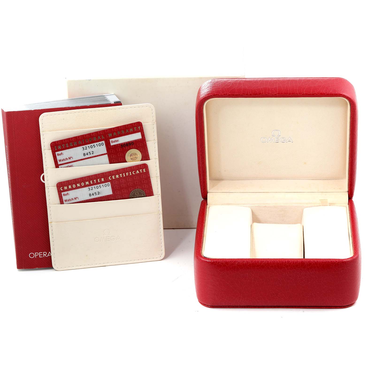 The image shows the accessories of an Omega Speedmaster 3210.51.00 Men's Stainless Steel Black Dial 3210.51.00 Men's Stainless Steel Black Dial, including the watch box, warranty cards, manual, and certificate holder.