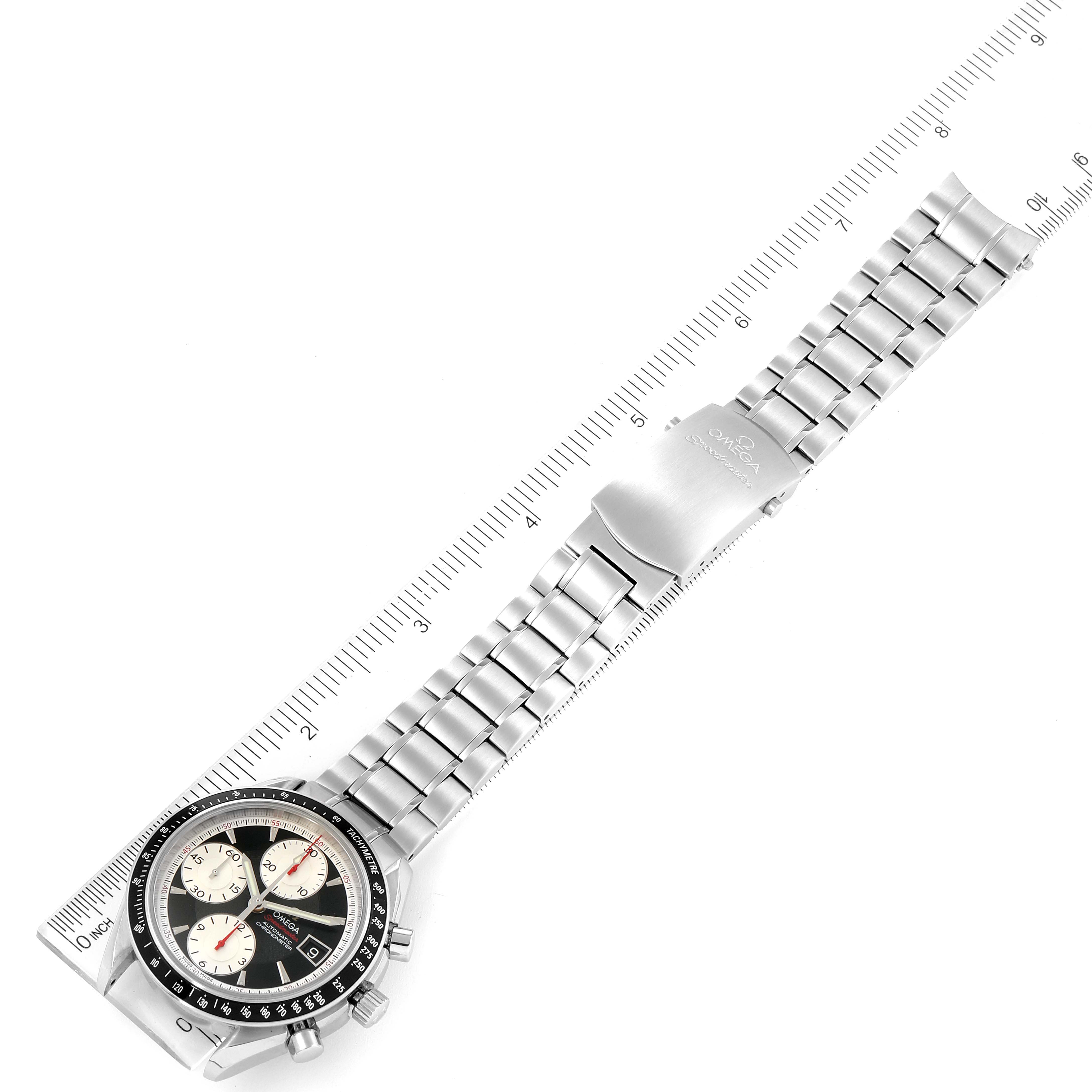 The Omega Speedmaster 3210.51.00 Men's Stainless Steel Black Dial 3210.51.00 Men's Stainless Steel Black Dial watch is shown in a top-down angle with its full stainless steel bracelet and clasp visible, placed next to a ruler.