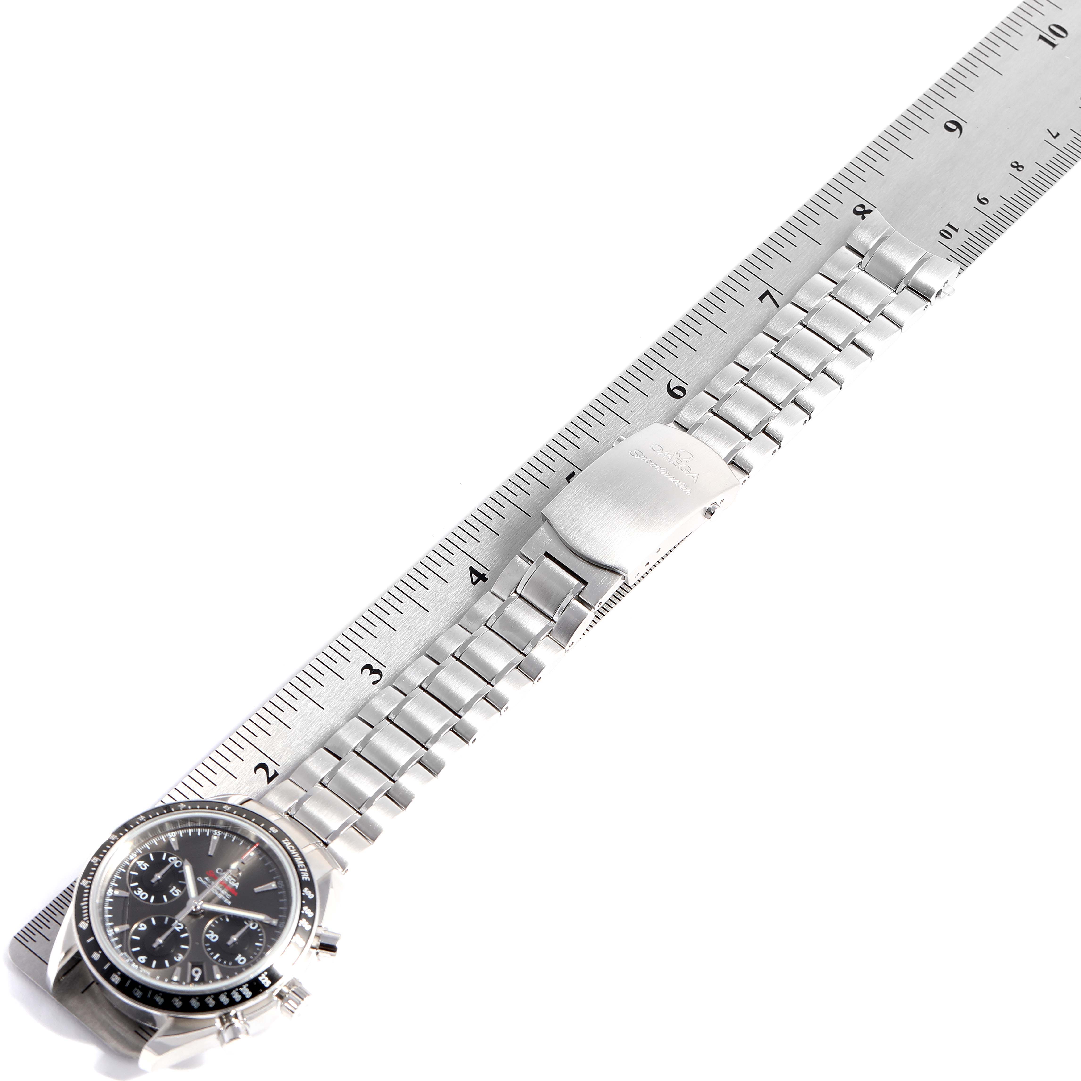 The Omega Speedmaster 323.30.40.40.06.001 Men's Stainless Steel Grey Dial 323.30.40.40.06.001 Men's Stainless Steel Grey Dial watch is shown from a top-down angle, displaying the face, bracelet, and clasp, alongside a ruler for scale.