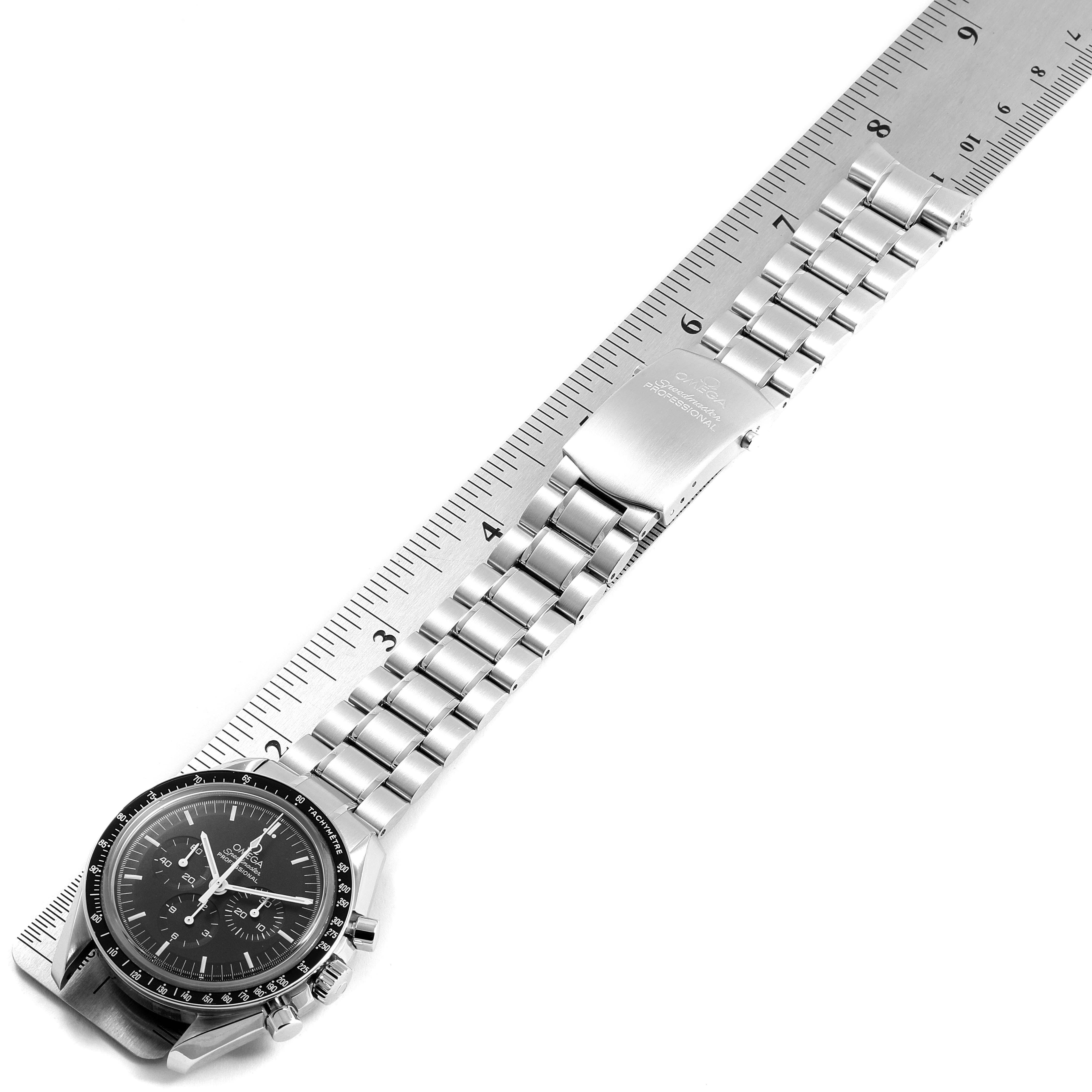 The Omega Speedmaster 311.30.42.30.01.006 Men
s Stainless Steel Black Dial 311.30.42.30.01.006 Men
s Stainless Steel Black Dial watch is shown laid flat with a stainless steel bracelet, clasp, and a portion of a ruler for scale.