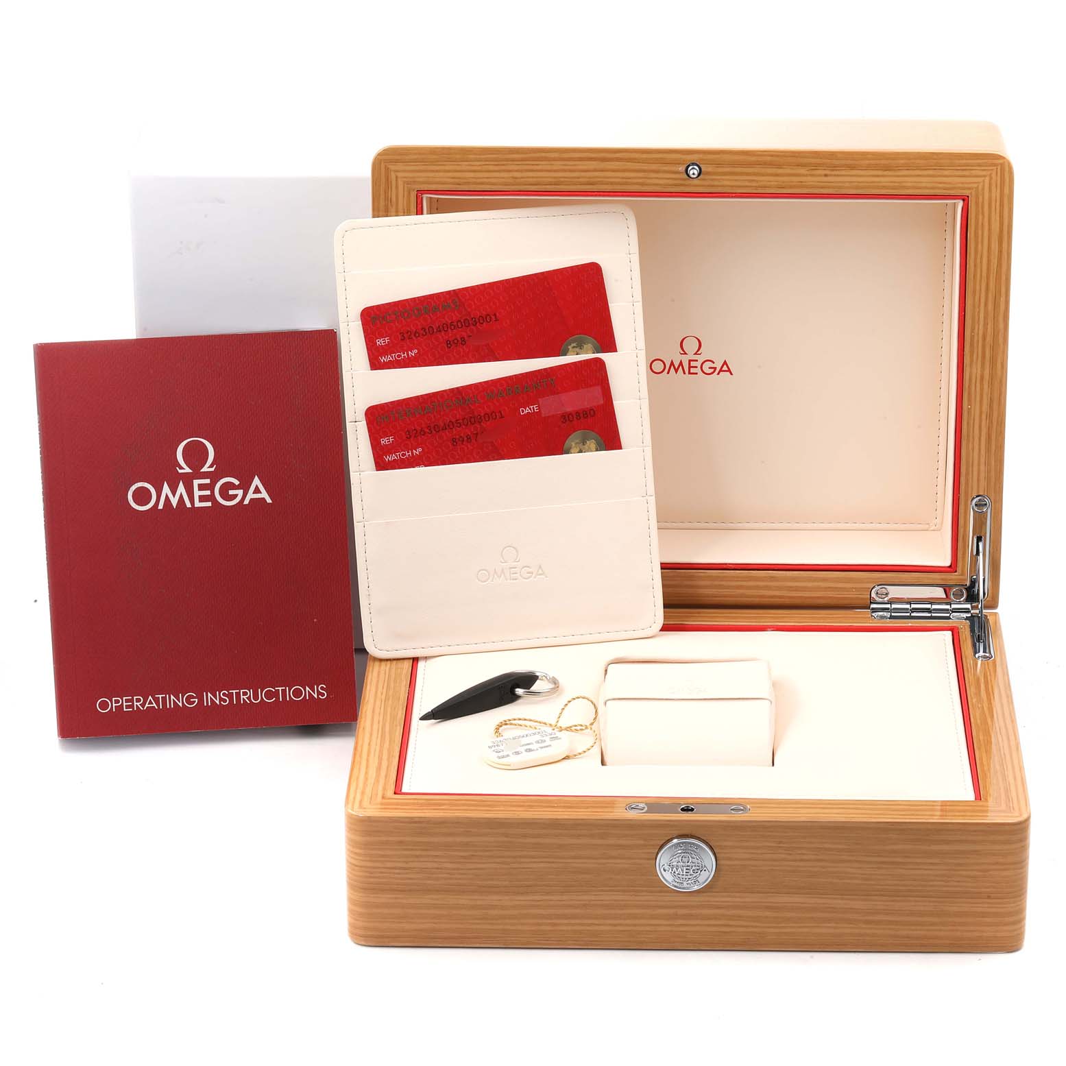 The image shows an open Omega Speedmaster 326.30.40.50.03.001 Men
s Stainless Steel Blue Dial 326.30.40.50.03.001 Men
s Stainless Steel Blue Dial watch box, warranty cards, operating instructions, and a tag.