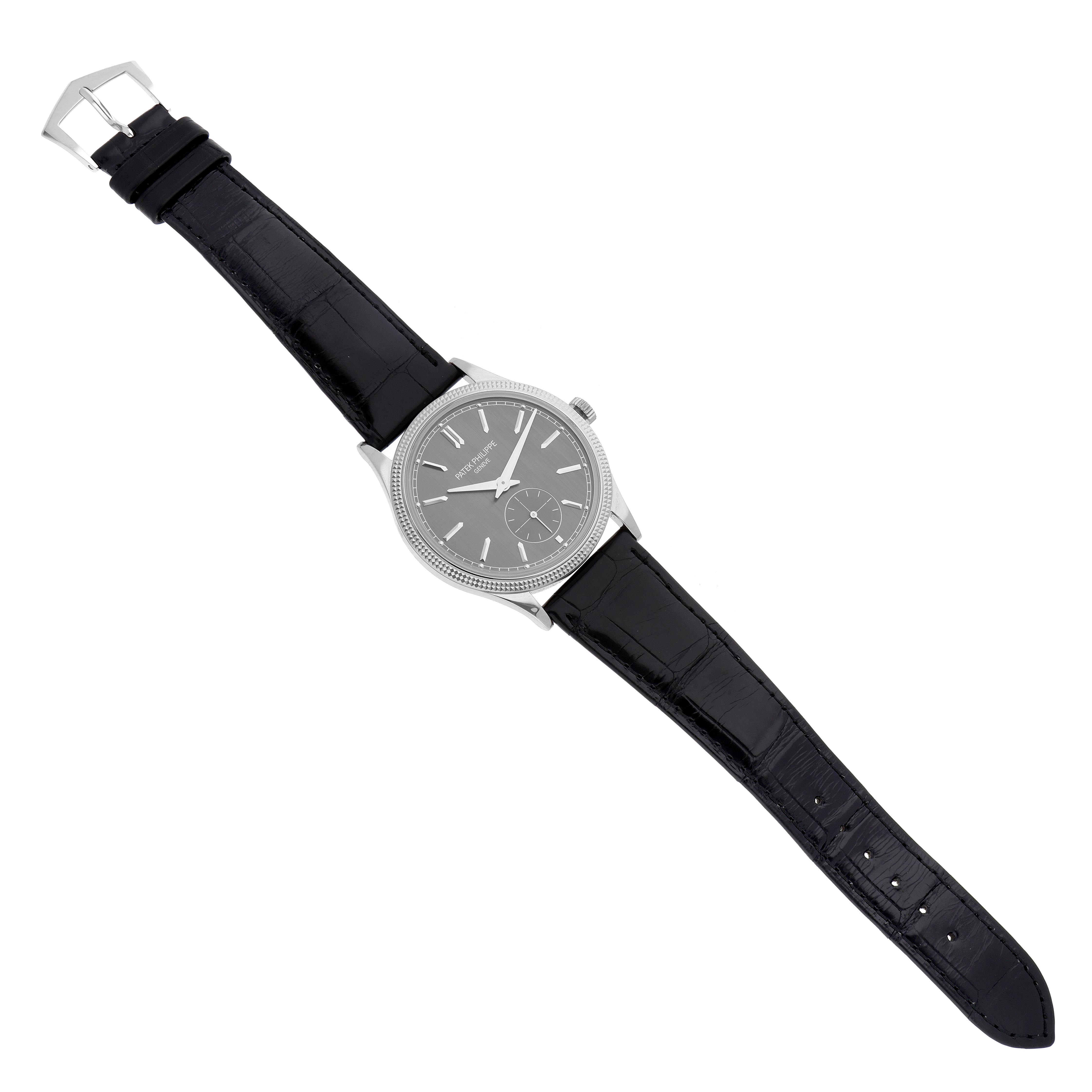 The Patek Philippe Calatrava 6119G Men's White Gold Grey Dial 6119G Men's White Gold Grey Dial watch is shown from a top view, displaying the face, case, lugs, and black leather strap.